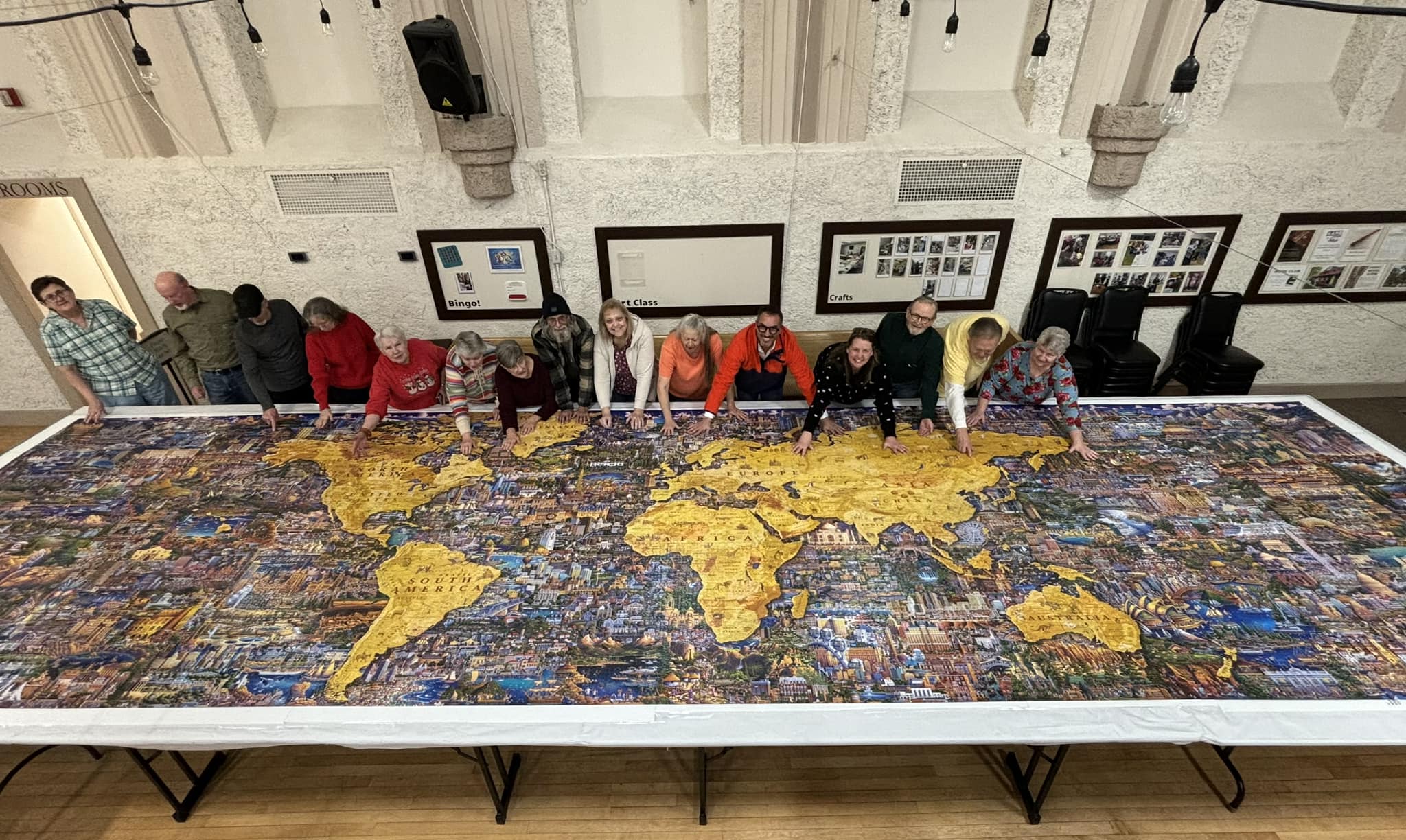 A group of seniors at the Springville Senior Center got to meet with puzzle maker and artist Eric Dowdle after they recently completed a 60,000-piece puzzle he designed.