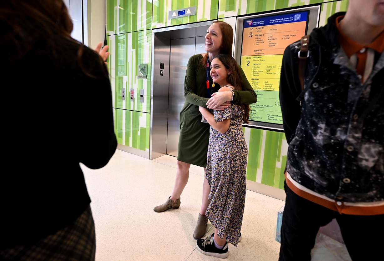 Nurse Stephanie Goodwin hugs her former patient Bailey Partida, who was injured and lost her right leg when she was 4 years old, as the new Intermountain Primary Children’s Hospital, Miller Family Campus, in Lehi is dedicated at a ceremony on Friday.