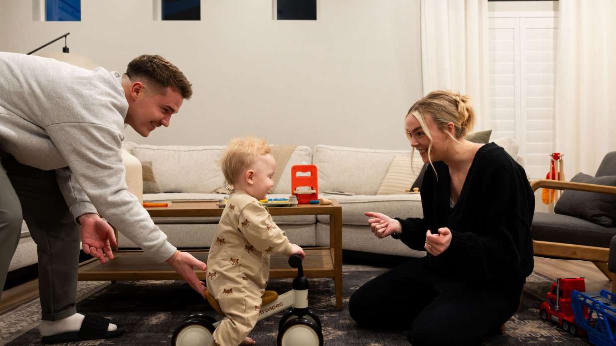 Cole and McCall Porter play with their son Jack, 1, at their home in Saratoga Springs on Jan. 31. The Porters purchased their first home in 2022. Although 2023 was not an ideal year for potential homebuyers, there is hope for 2024.