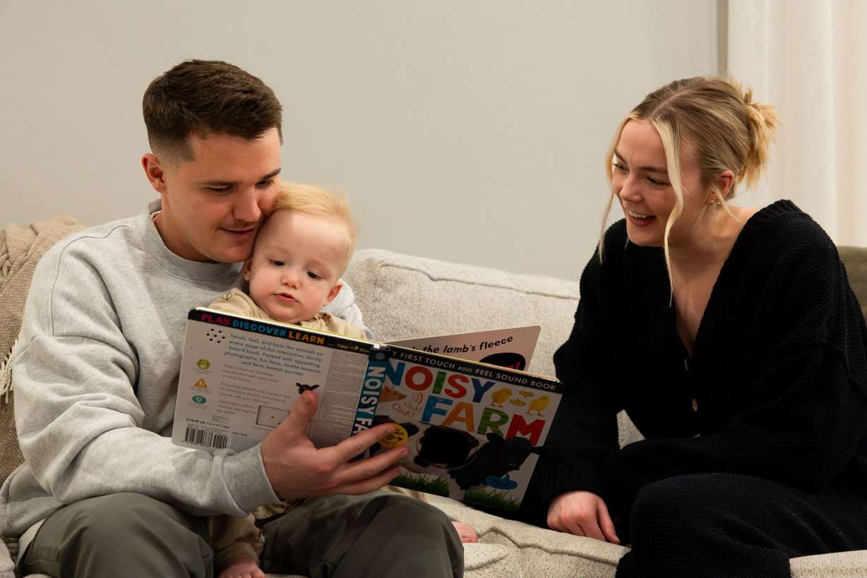 Cole and McCall Porter read a book to their son Jack, 1, at their home in Saratoga Springs on Jan. 31.