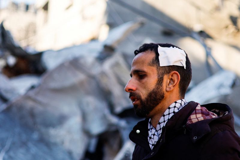 A wounded Palestinian man looks on at the site of an Israeli strike amid the ongoing conflict between Israel and Palestinian Islamist group Hamas, in Rafah in the southern Gaza Strip Feb. 3.