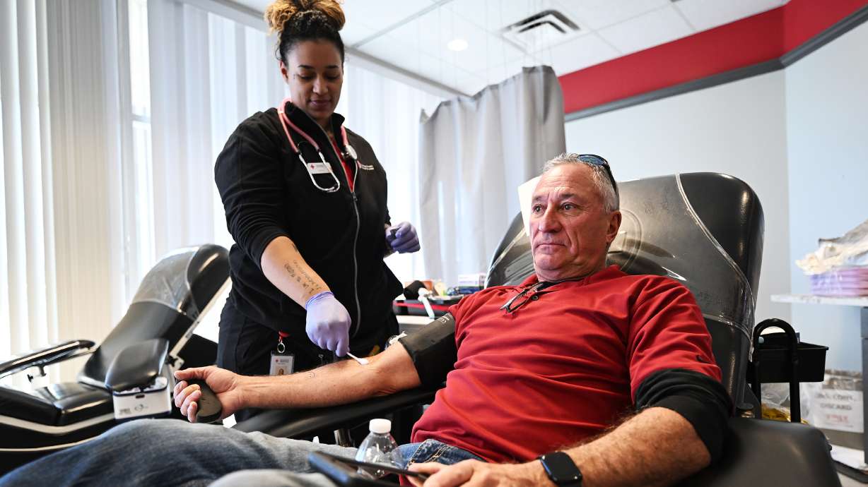 Dennis Druce is assisted in his blood donation by technician Shea Proctor at the American Red Cross Murray location on Jan. 8. The Red Cross is calling on Utahns to donate this summer.