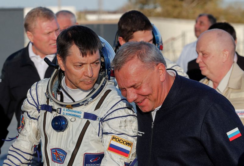 Chief of Russian space agency Roscosmos Yuri Borisov accompanies cosmonaut Oleg Kononenko, who boards the Soyuz MS-24 spacecraft at the Baikonur cosmodrome, Kazakhstan, Sept. 15, 2023.