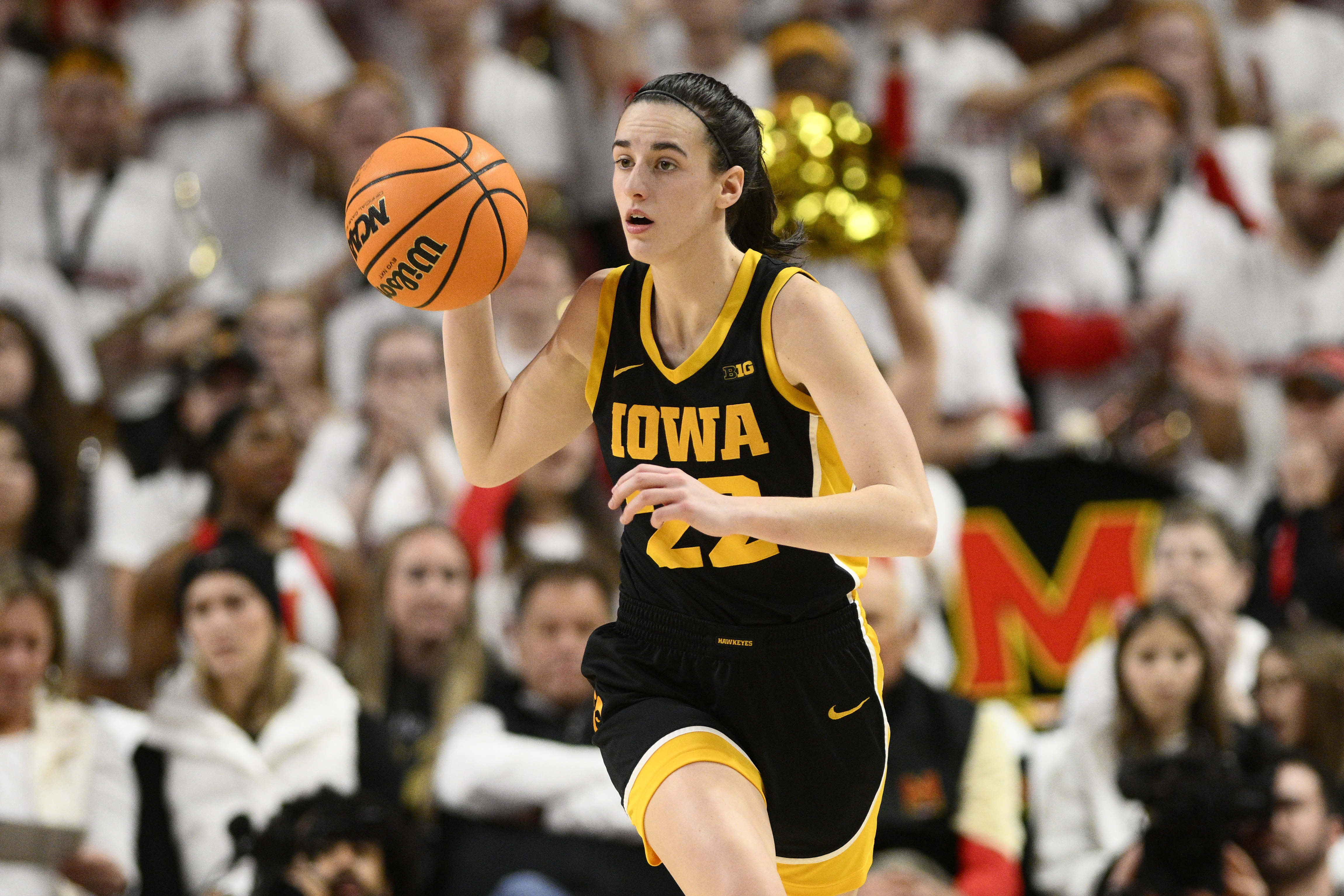 Iowa guard Caitlin Clark dribbles during the first half of an NCAA college basketball game against Maryland, Saturday, Feb. 3, 2024, in College Park, Md. 