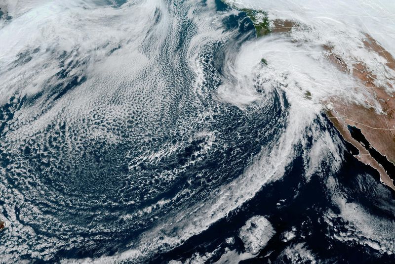 A "Pineapple Express" weather system, or atmospheric river storm, moves towards the West Coast in a composite image from the National Oceanic and Atmospheric Administration GOES-West weather satellite Sunday.
