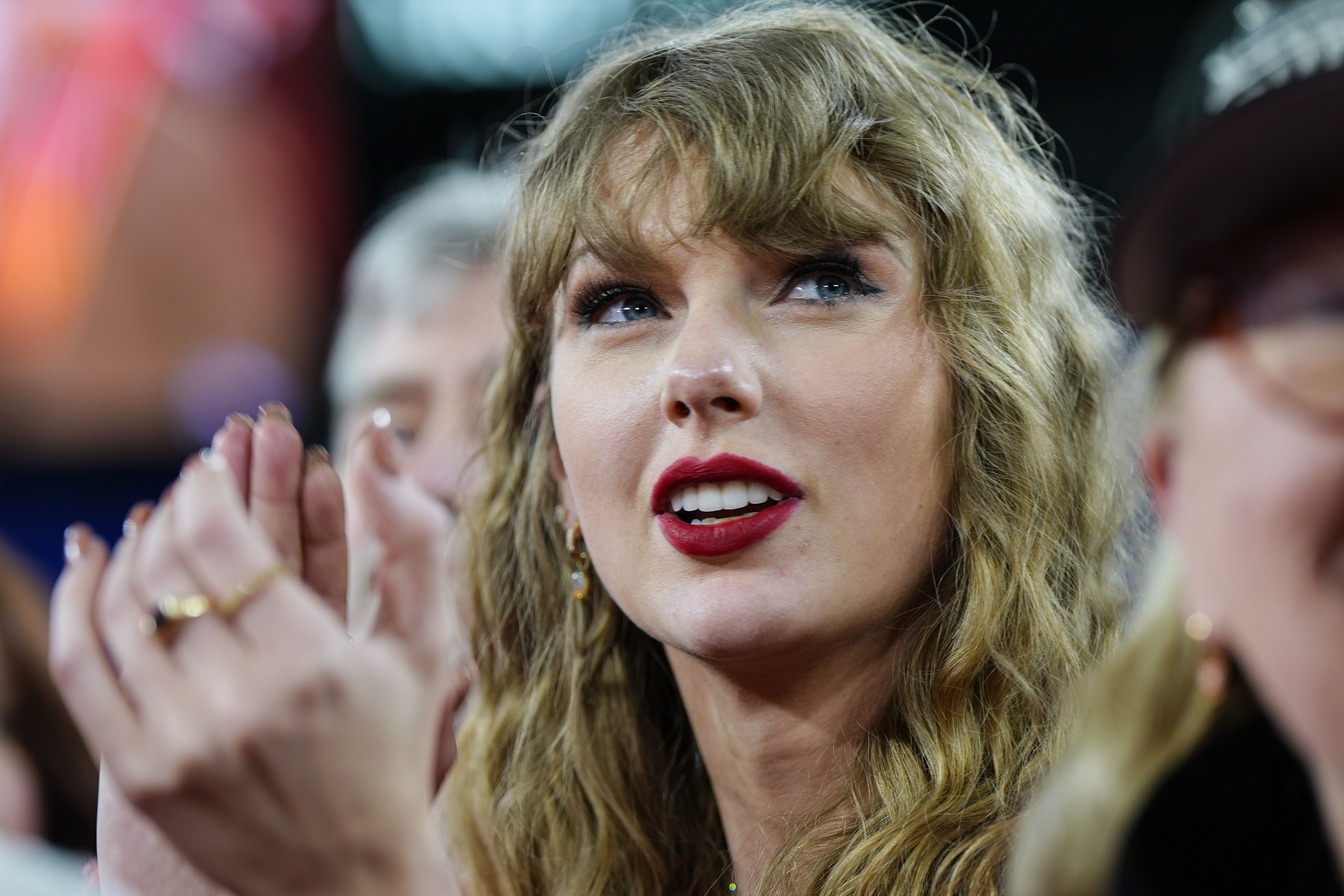 FILE - Taylor Swift stands on the field after an AFC Championship NFL football game between the Baltimore Ravens and the Kansas City Chiefs, Sunday, Jan. 28, 2024, in Baltimore. Taylor Swift, who is holding concerts in Japan, will make it in time for the Super Bowl to see her partner and football superstar Travis Kelce play. 