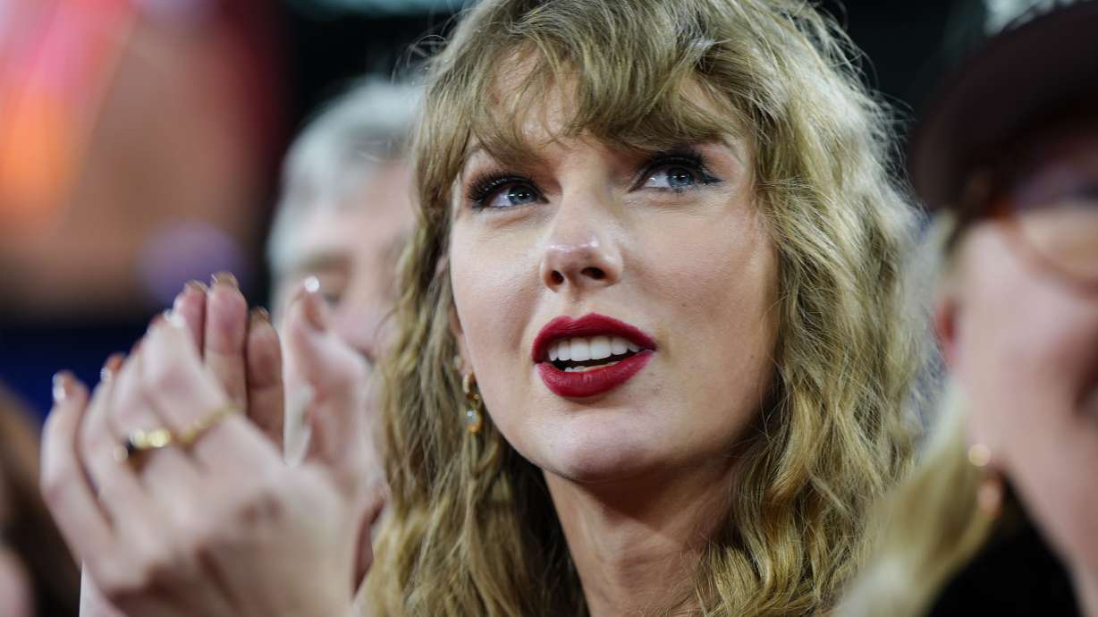 FILE - Taylor Swift stands on the field after an AFC Championship NFL football game between the Baltimore Ravens and the Kansas City Chiefs, Sunday, Jan. 28, 2024, in Baltimore. Taylor Swift, who is holding concerts in Japan, will make it in time for the Super Bowl to see her partner and football superstar Travis Kelce play.