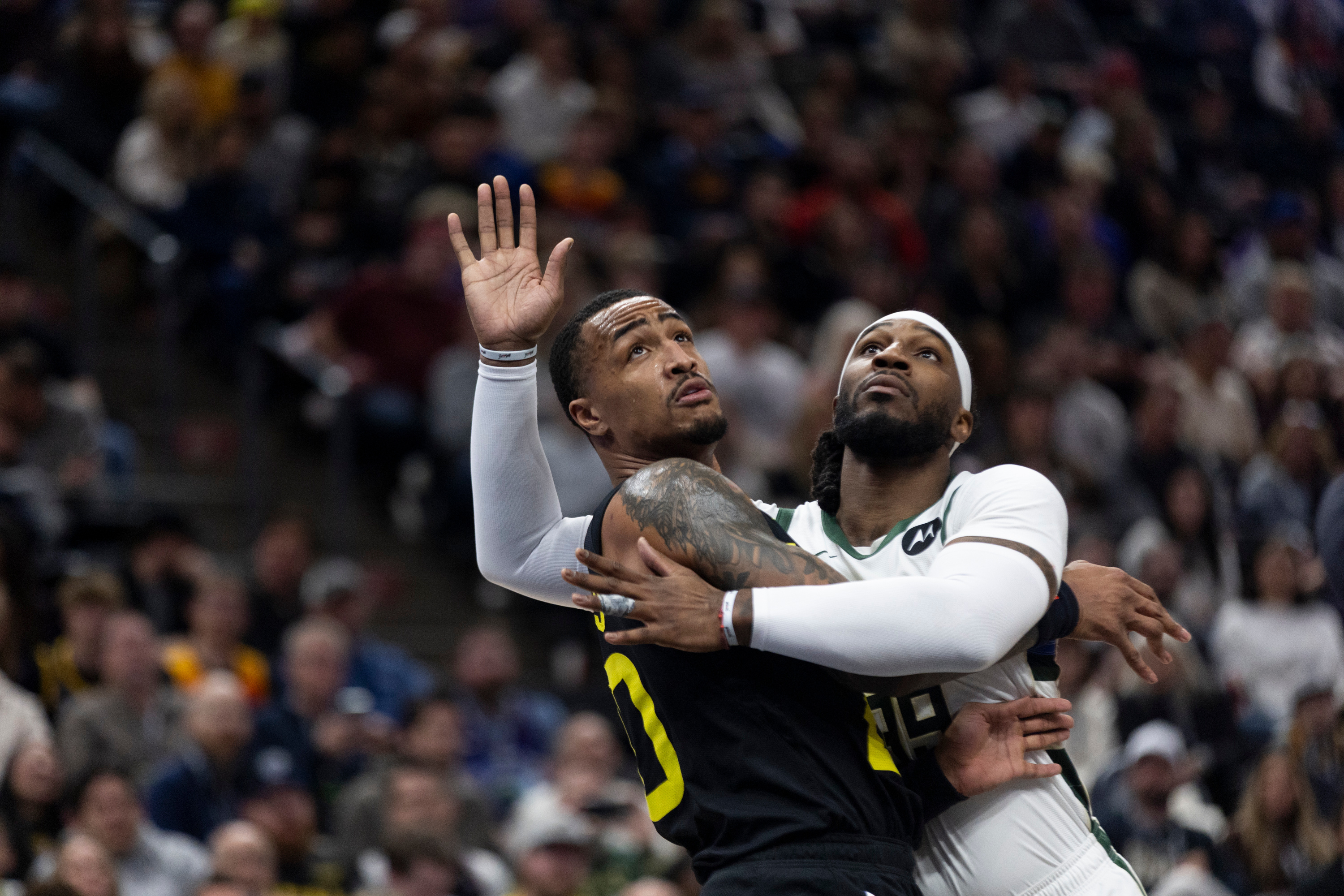 Utah Jazz forward John Collins (20) blocks Milwaukee Bucks forward Jae Crowder (99) during an NBA game at the Delta Center in Salt Lake City on Sunday, Feb. 4, 2024.