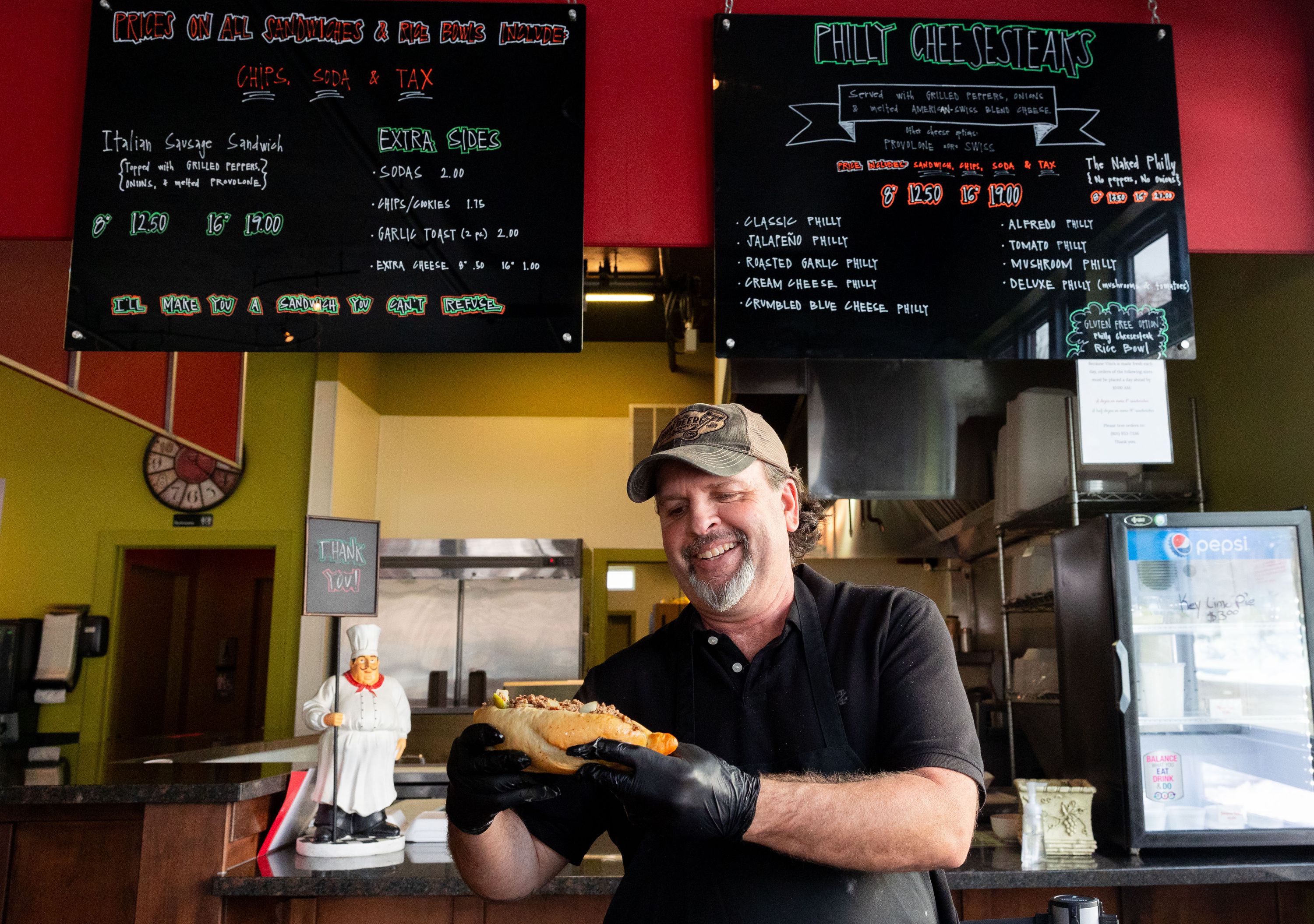Vito Leone, owner of Vito’s, poses for a portrait holding a Philly cheesesteak at Vito’s in Bountiful on Jan. 8. Vito’s is a cash-only eatery specializing in Philly cheesesteaks.