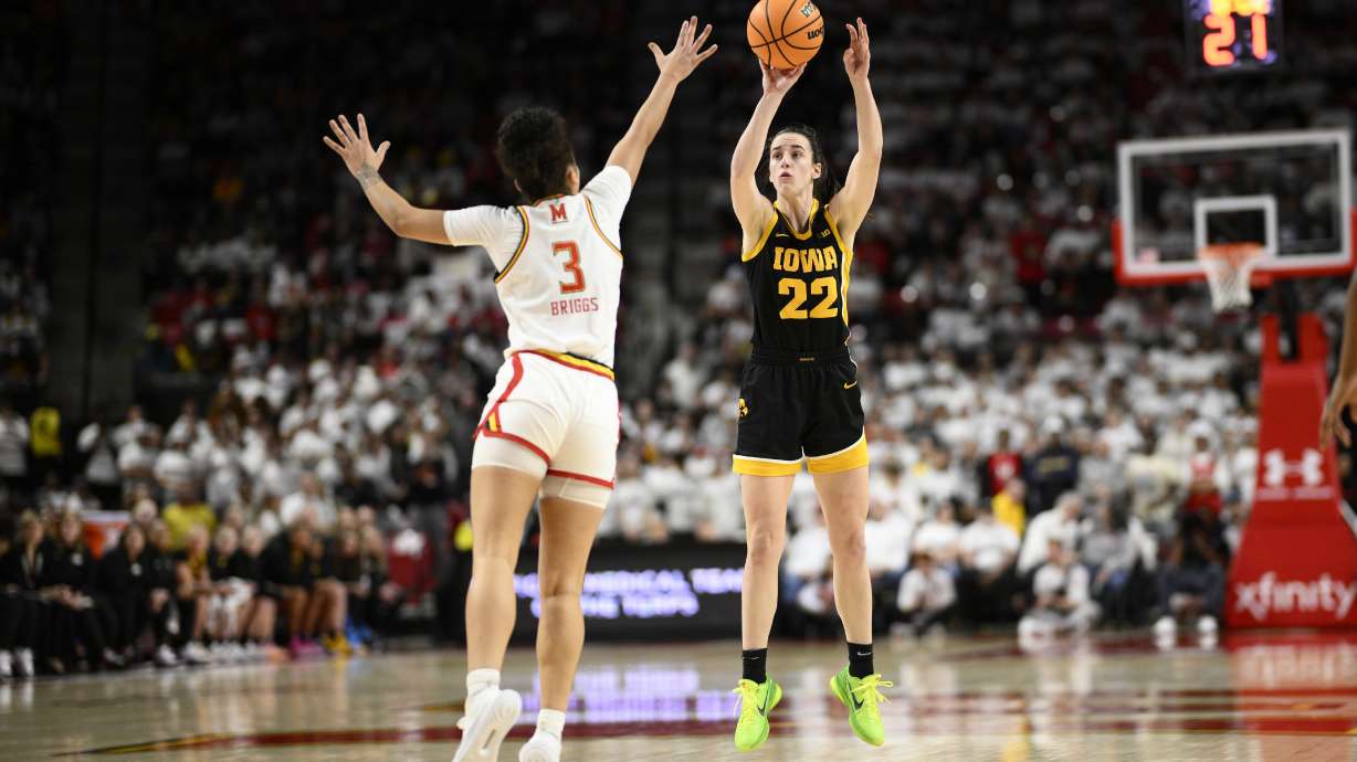 Iowa guard Caitlin Clark (22) shoots against Maryland guard Lavender Briggs (3) during the first half of an NCAA college basketball game, Saturday, Feb. 3, 2024, in College Park, Md.