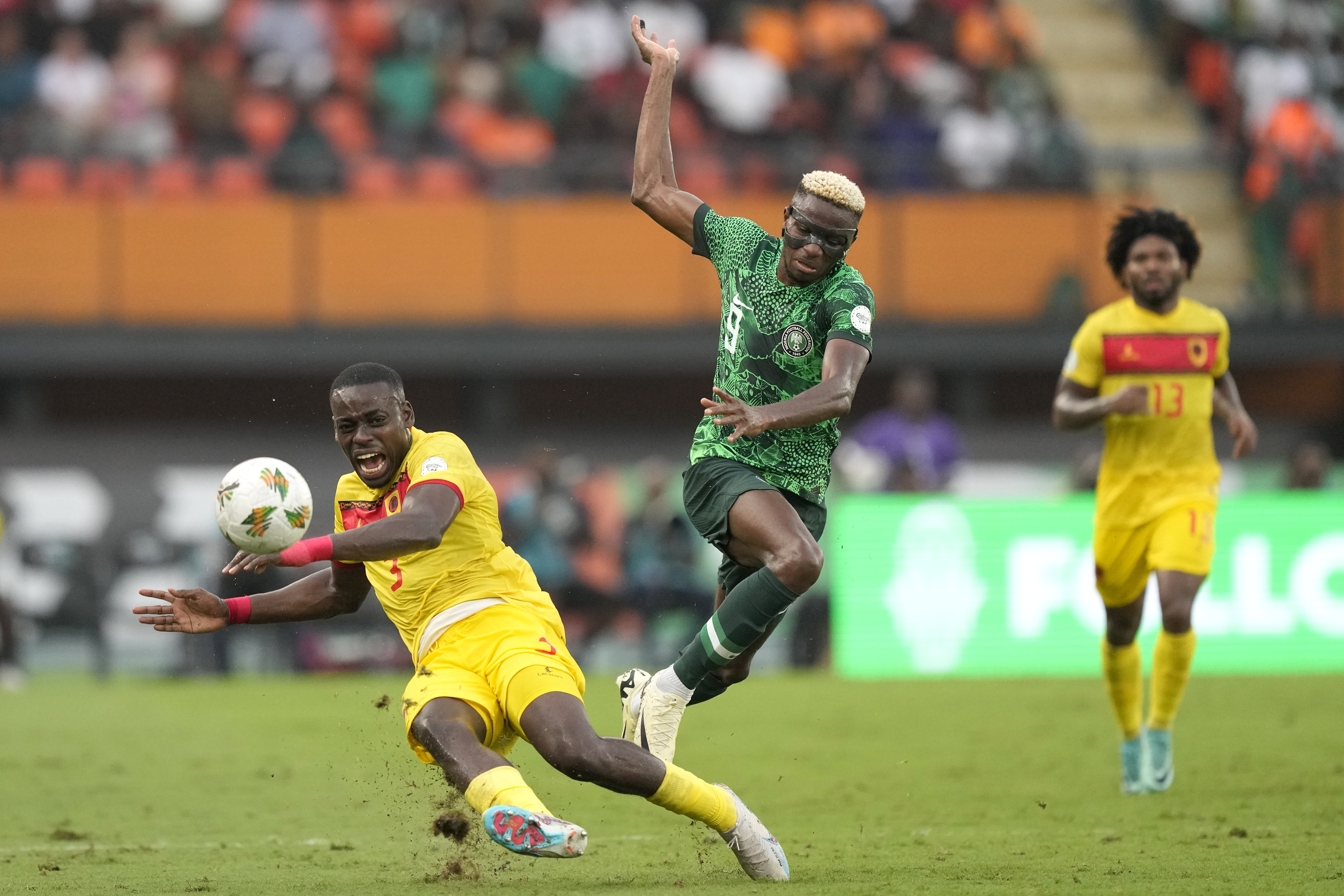 Nigeria's Victor Osimhen, right, challenges Angola's Jonathan Buatu during the African Cup of Nations quarterfinal soccer match between Nigeria and Angola, at the Felix Houphouet Boigny stadium in Abidjan, Ivory Coast, Friday, Feb. 2, 2024. 2024.