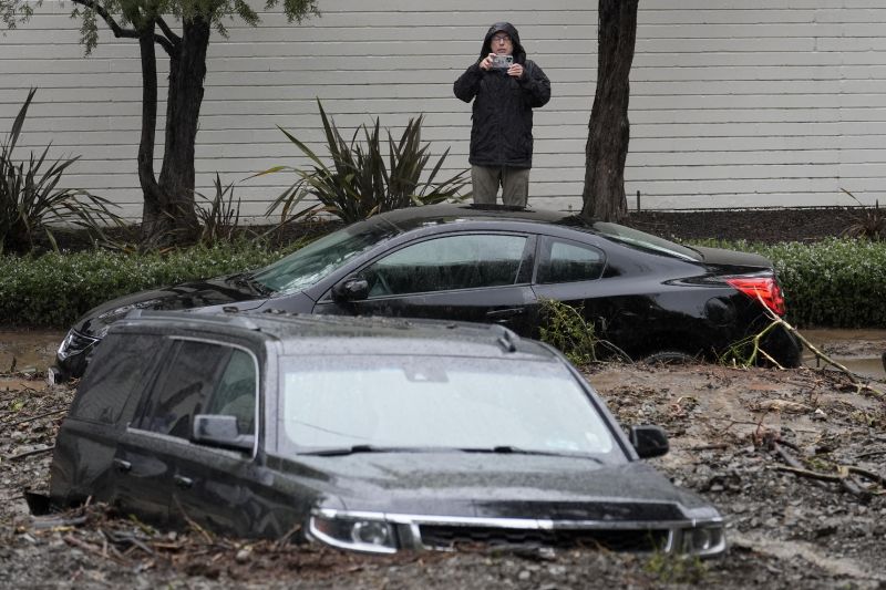 Submerged vehicles are photographed after a mudslide, Monday in the Beverly Crest area of Los Angeles.