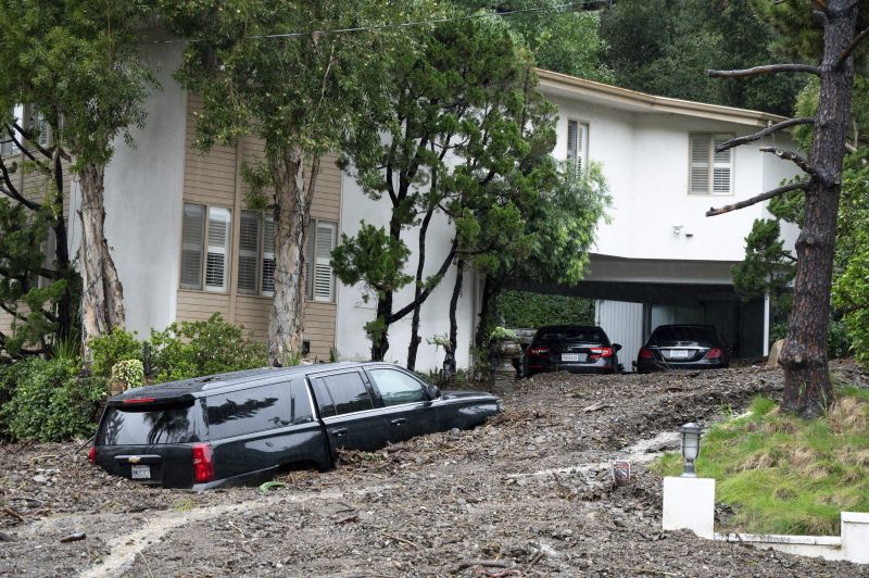 A large mudslide that occurred at the intersection of Beverly Drive and Beverly Place in the Beverly Crest area of Los Angeles damaged homes and cars on Monday. Rain is expected to continue in Southern California over the next 12 hours.
