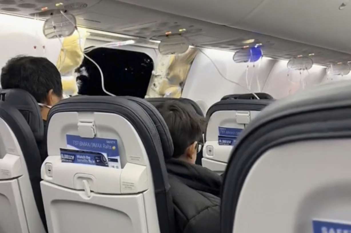 This image from video shows passengers near the damage on an Alaska Airlines Boeing 737 Max 9, Flight 1282, which was forced to return to Portland International Airport on Jan. 5.