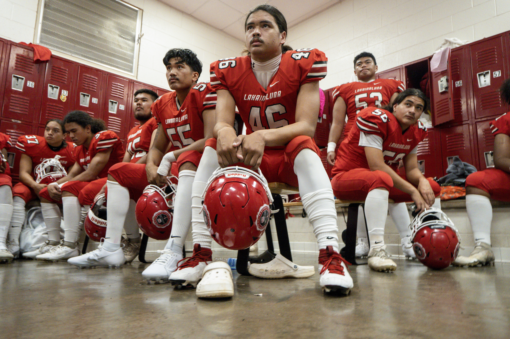 FILE - Lahainaluna High School football team players listens to co-head coach Dean Rickard before their homecoming game at Sue D. Cooley Stadium, Saturday, Oct. 21, 2023, in Lahaina, Hawaii. Captains of the team whose town was destroyed by a deadly wildfire are going to Super Bowl in Las Vegas as guests of the NFL. The Maui News reports the four students and three of their coaches will be serving as honorary coin toss captains before the game between the Kansas City Chiefs and the San Francisco 49ers. 