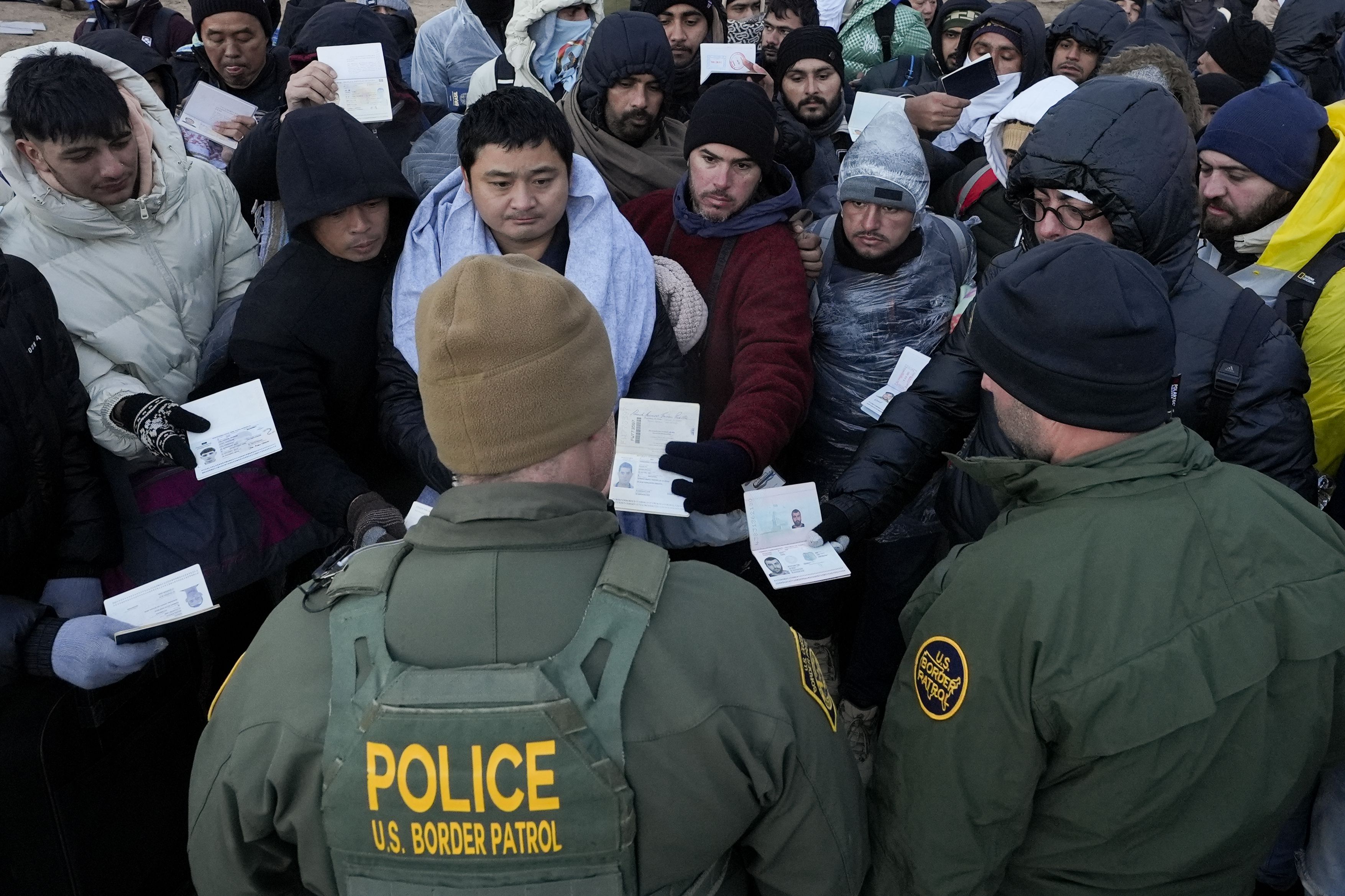 Border Patrol agents speak with asylum-seeking migrants Feb. 2 near Jacumba Hot Springs, Calif. Sen. Mitt Romney said he is “deeply disappointed” with the GOP’s decision to walk away from the $118 billion border deal.