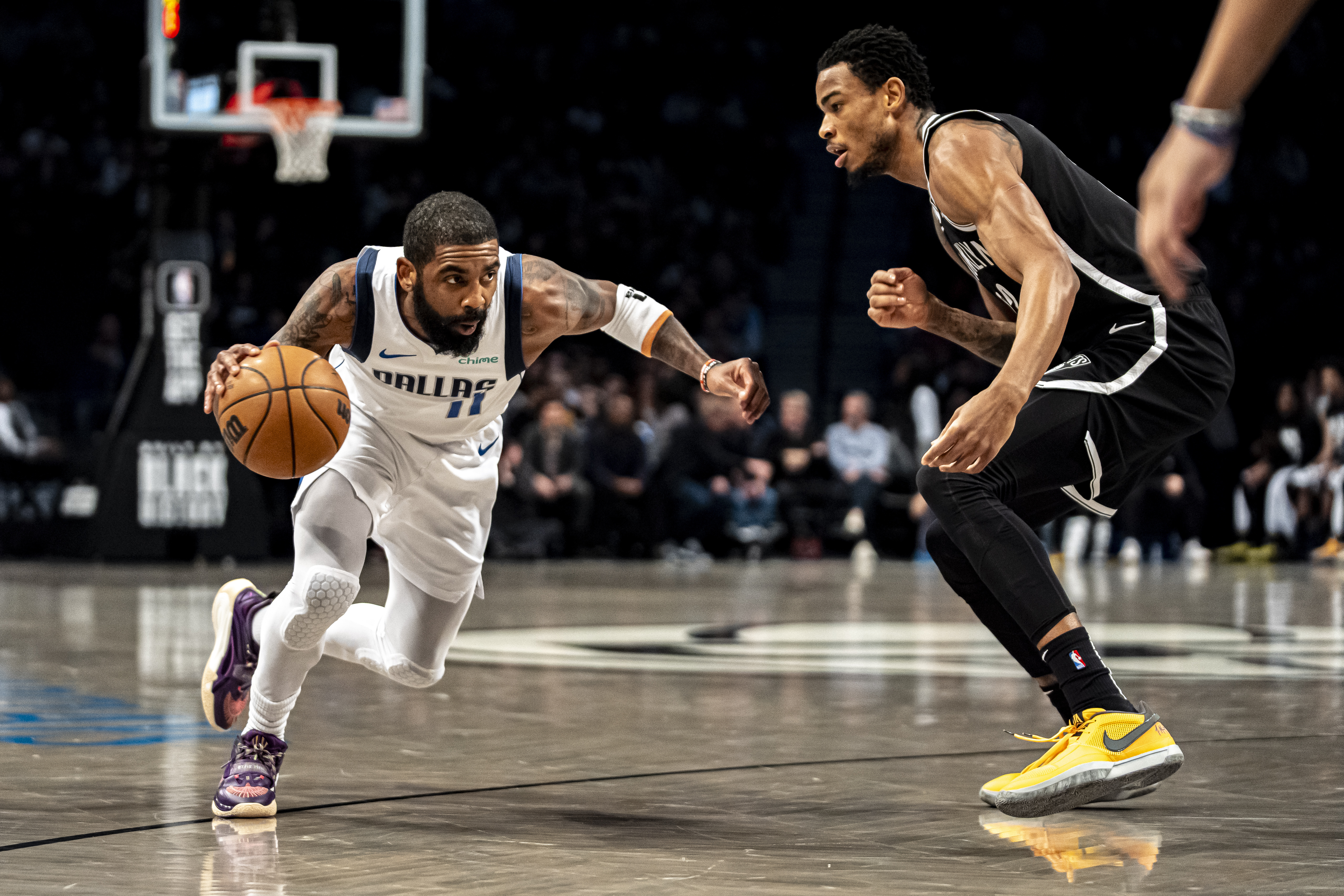 Dallas Mavericks guard Kyrie Irving (11) drives to the basket against Brooklyn Nets center Nic Claxton during the first half of an NBA basketball game in New York, Tuesday, Feb. 6, 2024. 