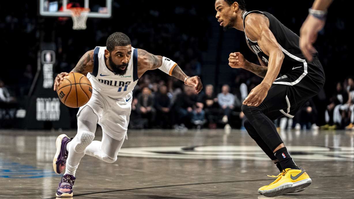 Dallas Mavericks guard Kyrie Irving (11) drives to the basket against Brooklyn Nets center Nic Claxton during the first half of an NBA basketball game in New York, Tuesday, Feb. 6, 2024.