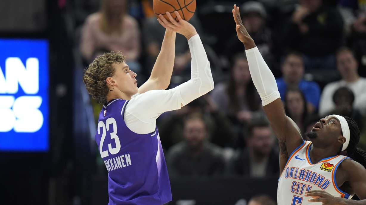 Utah Jazz forward Lauri Markkanen (23) shoots as Oklahoma City Thunder guard Luguentz Dort (5) defends during the first half of an NBA basketball game Tuesday, Feb. 6, 2024, in Salt Lake City.
