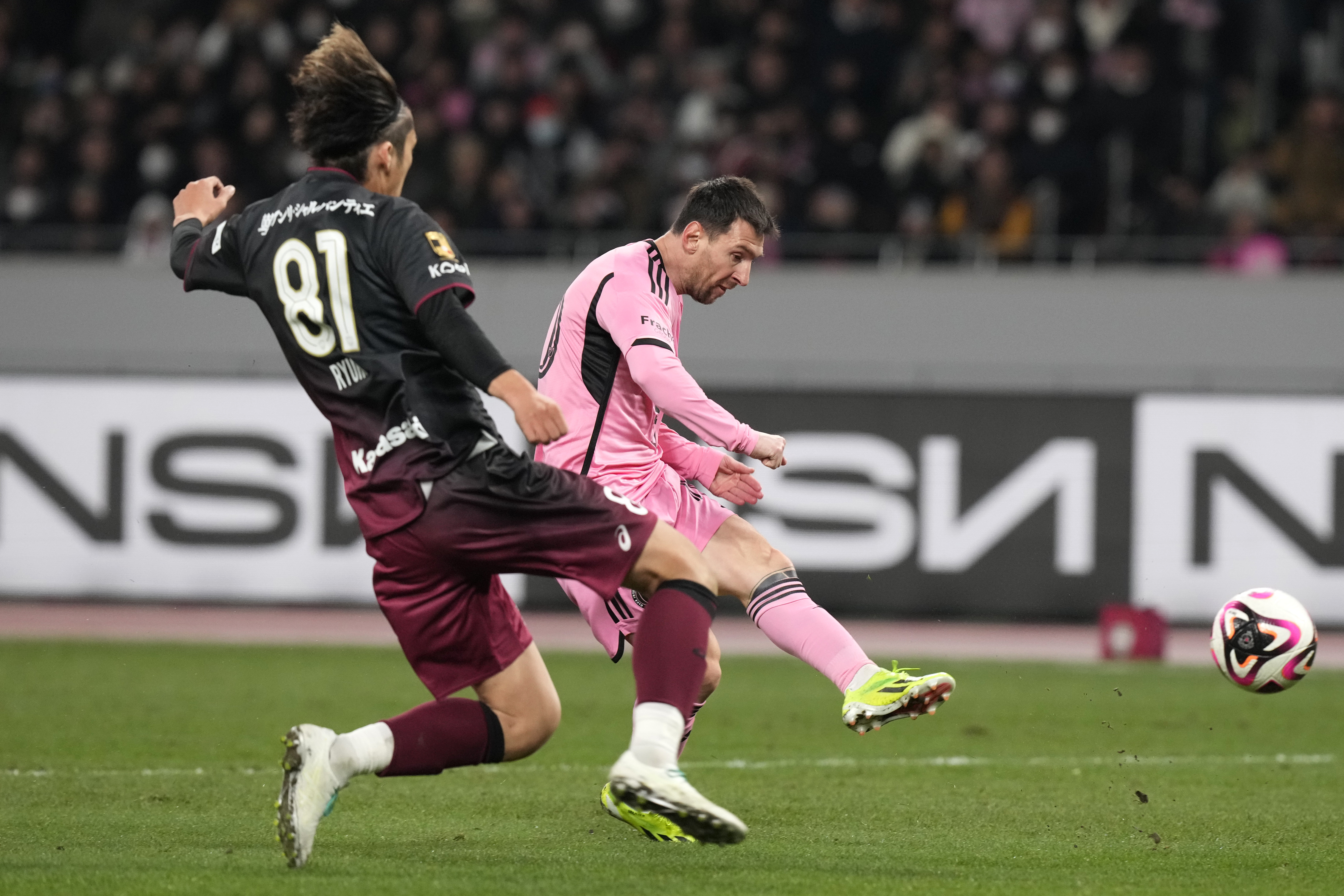 Inter Miami's Lionel Messi, right, battles for the ball against Vissel Kobe's Ryuho Kikuchi during the friendly soccer match between Vissel Kobe and Inter Miami CF at the National Stadium, Wednesday, Feb. 7, 2024, in Tokyo, Japan. 