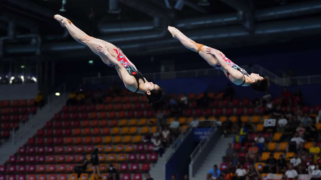 Yani Chang and Yiwen Chen of China compete during the women's synchronized 3m springboard diving final at the World Aquatics Championships in Doha, Qatar, Wednesday, Feb. 7, 2024.