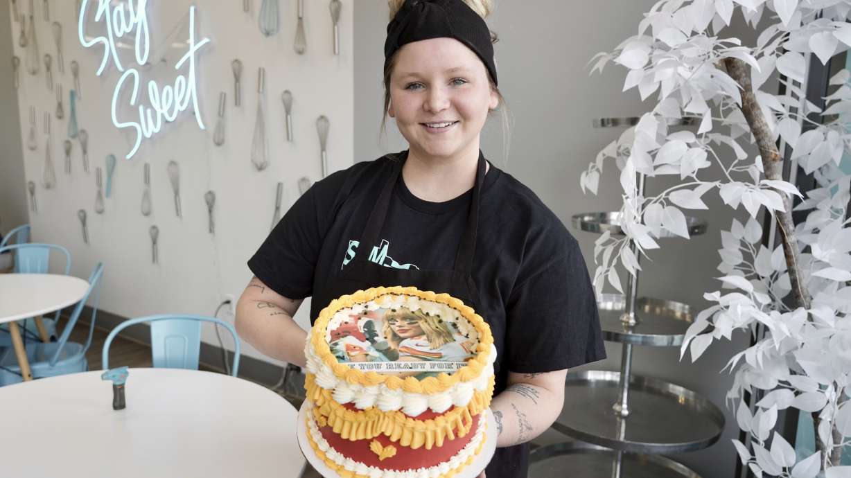 Maddie Schmitz, owner of Something Sweet by Maddie Lu, displays one of her "burn away cakes" in Coon Rapids, Minn., Monday, Feb. 5, 2024. Schmitz created the Taylor Swift/Travis Kelce cakes just in time for NFL football's upcoming Super Bowl.