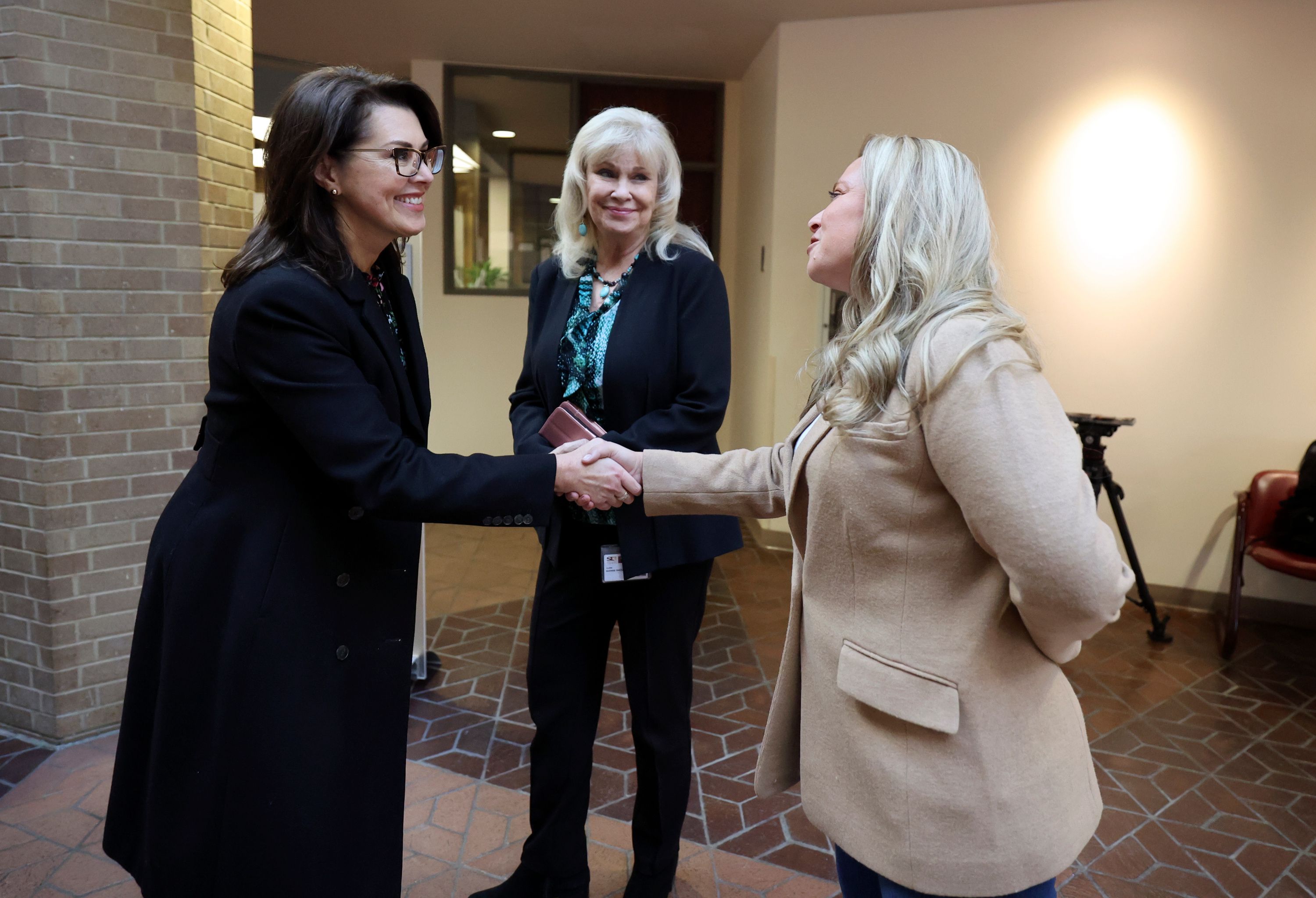 Lt. Gov. Deidre Henderson greets Sherrie Swenson and Lannie Chapman in Salt Lake City on Nov. 3, 2022. A bill to create an "independent state agency" to oversee elections isn't going to be considered during this session of the Utah Legislature.