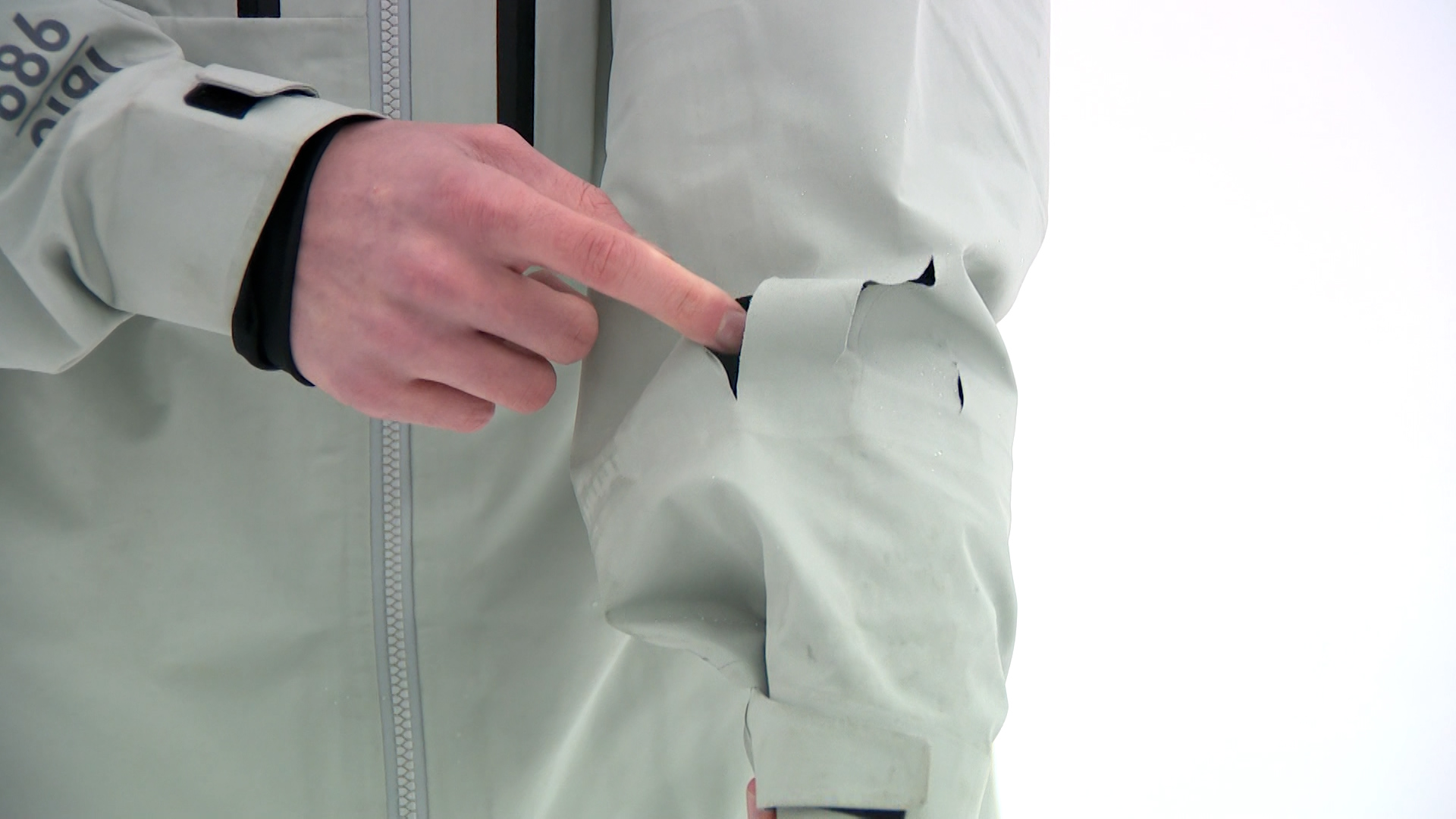 Charlie Duffy shows the holes in his jacket left after the mountain lion swiped at him on Sunday on Beaver Mountain.