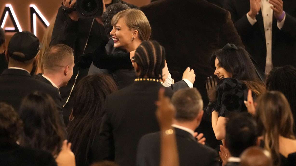 Jack Antonoff, left, and Taylor Swift embrace as Swift wins the award for best pop vocal album for "Midnights" during the 66th annual Grammy Awards on Sunday, Feb. 4, 2024, in Los Angeles.