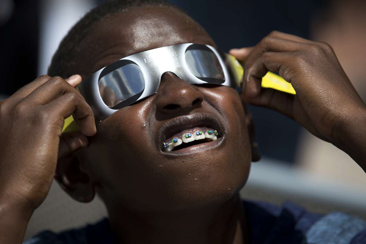Blake Davis, 10, of Coral Springs, Fla., looks through solar glasses as he watches the eclipse, Monday, Aug. 21, 2017, at Nova Southeastern University in Davie, Fla. After April 8, 2024, there won’t be another U.S. eclipse, spanning coast to coast, until 2045. That one will stretch from Northern California all the way to Cape Canaveral, Florida.