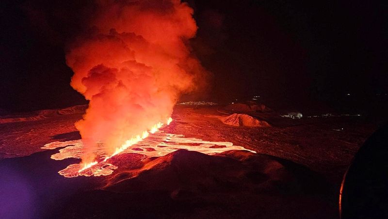 A volcano spews lava and smoke as it erupts on Reykjanes Peninsula in Iceland Thursday.
