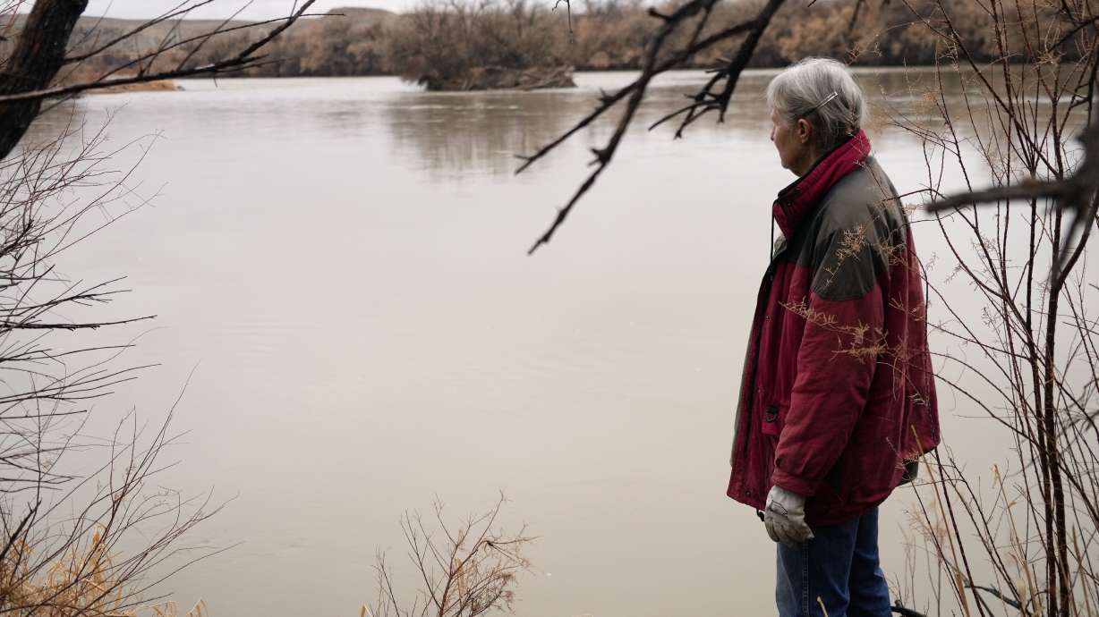 Gayna Salinas looks out over the Green River, a tributary of the Colorado River, Jan. 25 in Green River. An Australian company and its U.S. subsidiaries are eyeing a nearby area to extract lithium, metal used in electric vehicle batteries.