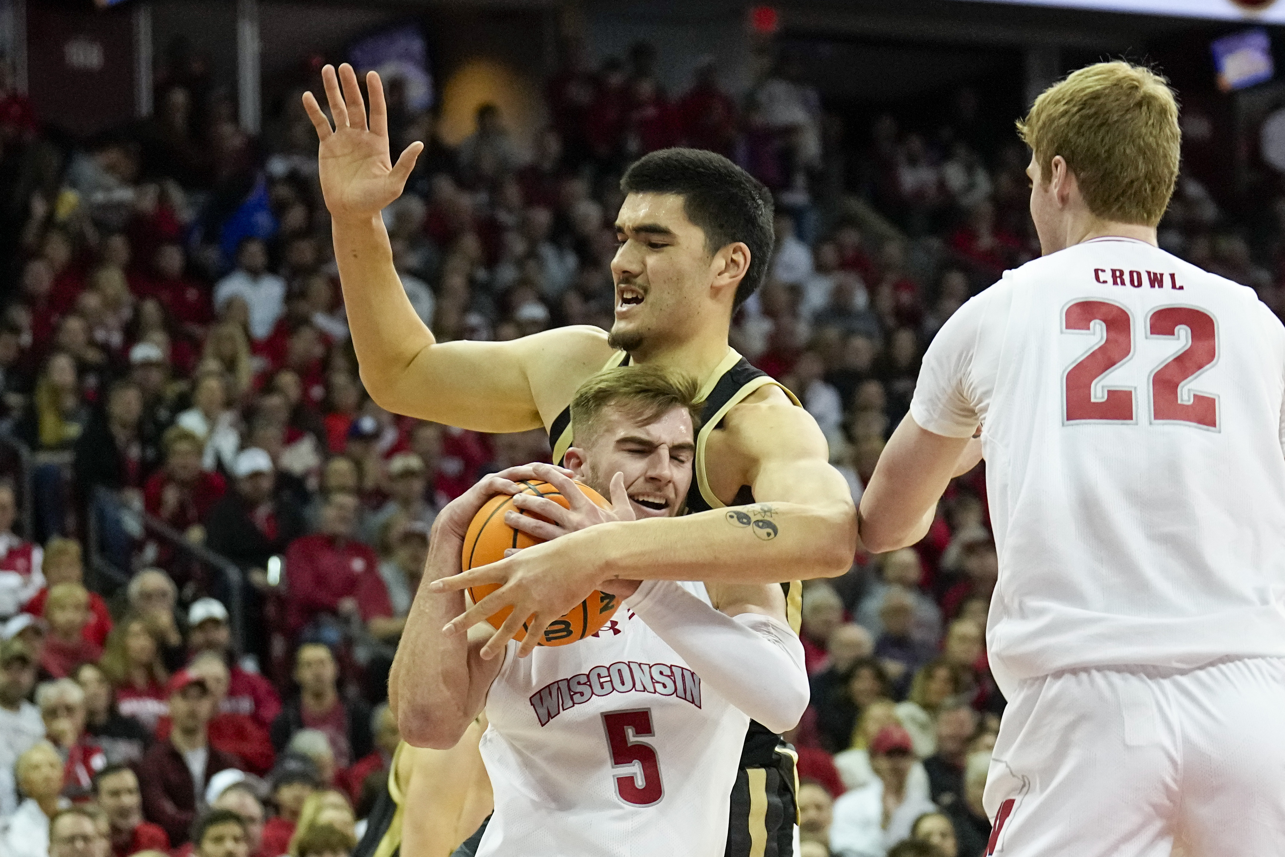 Wisconsin's Tyler Wahl (5) grabs a loose ball away from Purdue's Zach Edey (15) during the first half of an NCAA college basketball game Sunday, Feb. 4, 2024, in Madison, Wis. 