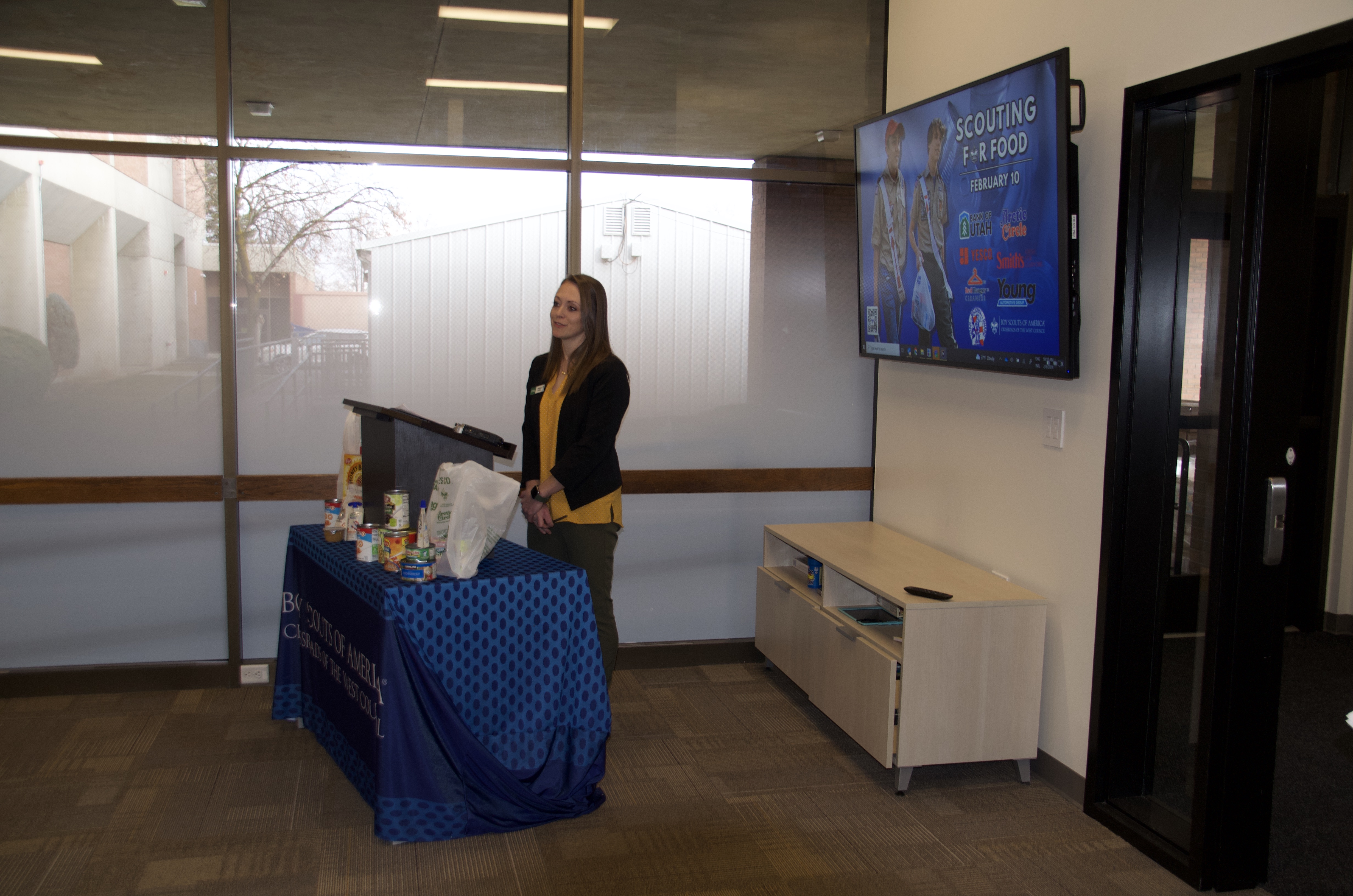 Megan Kenley, marketing and communications specialist for Bank of Utah, speaks at the Scouting for Food kick-off event held at Cottonwood High School's Teen Center on Thursday.
