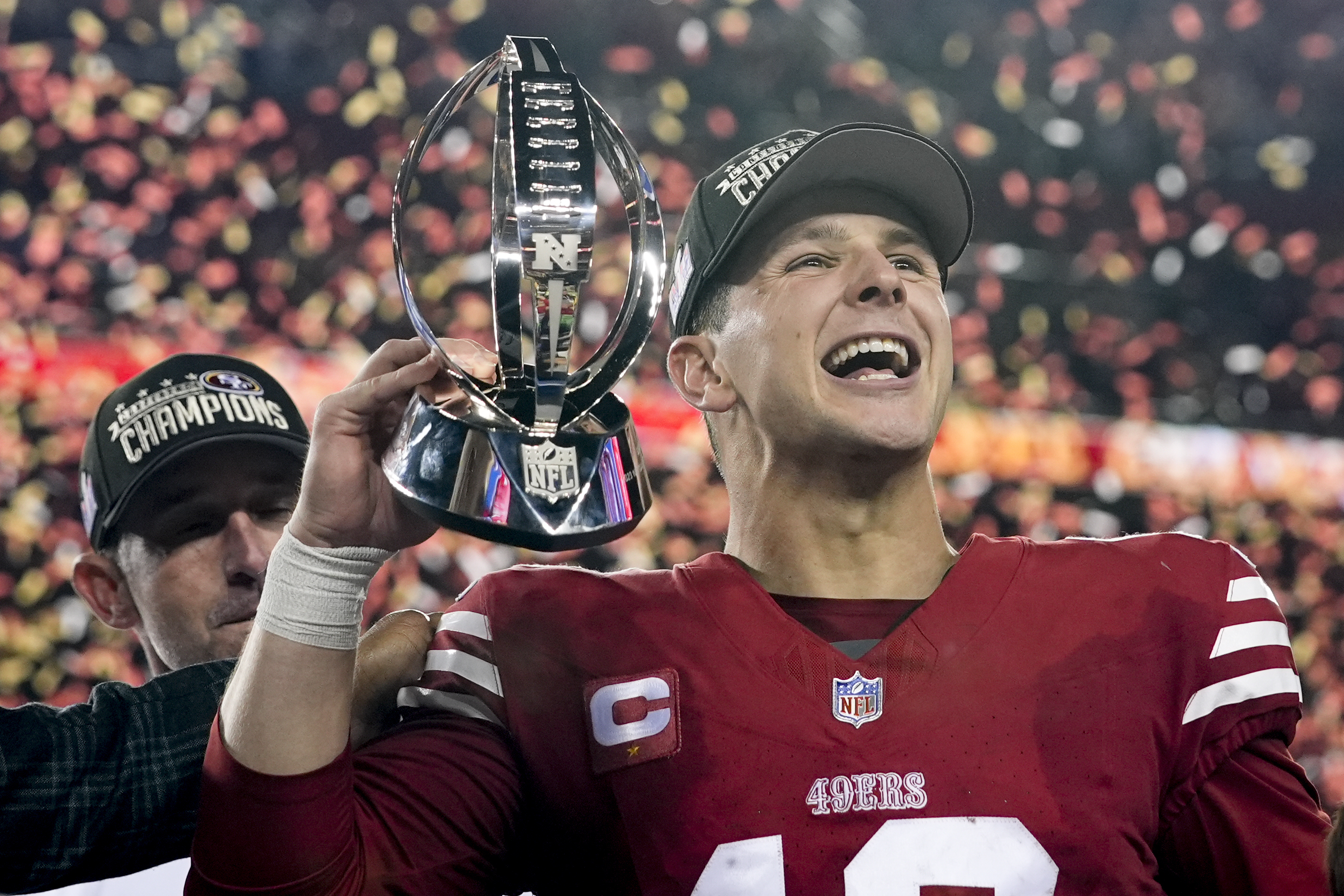 San Francisco 49ers quarterback Brock Purdy celebrates with the trophy after their win against the Detroit Lions in the NFC Championship NFL football game in Santa Clara, Calif., Sunday, Jan. 28, 2024.