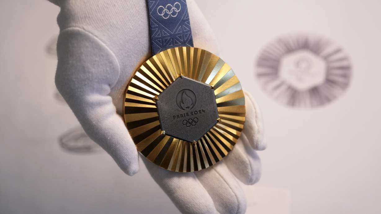 The Paris 2024 Olympic gold medal is presented to the press, in Paris, Thursday, Feb. 1, 2024. A hexagonal, polished piece of iron taken from the Eiffel Tower is being embedded in each gold, silver and bronze medal that will be hung around athletes' necks at the July 26-Aug. 11 Paris Games and Paralympics that follow.