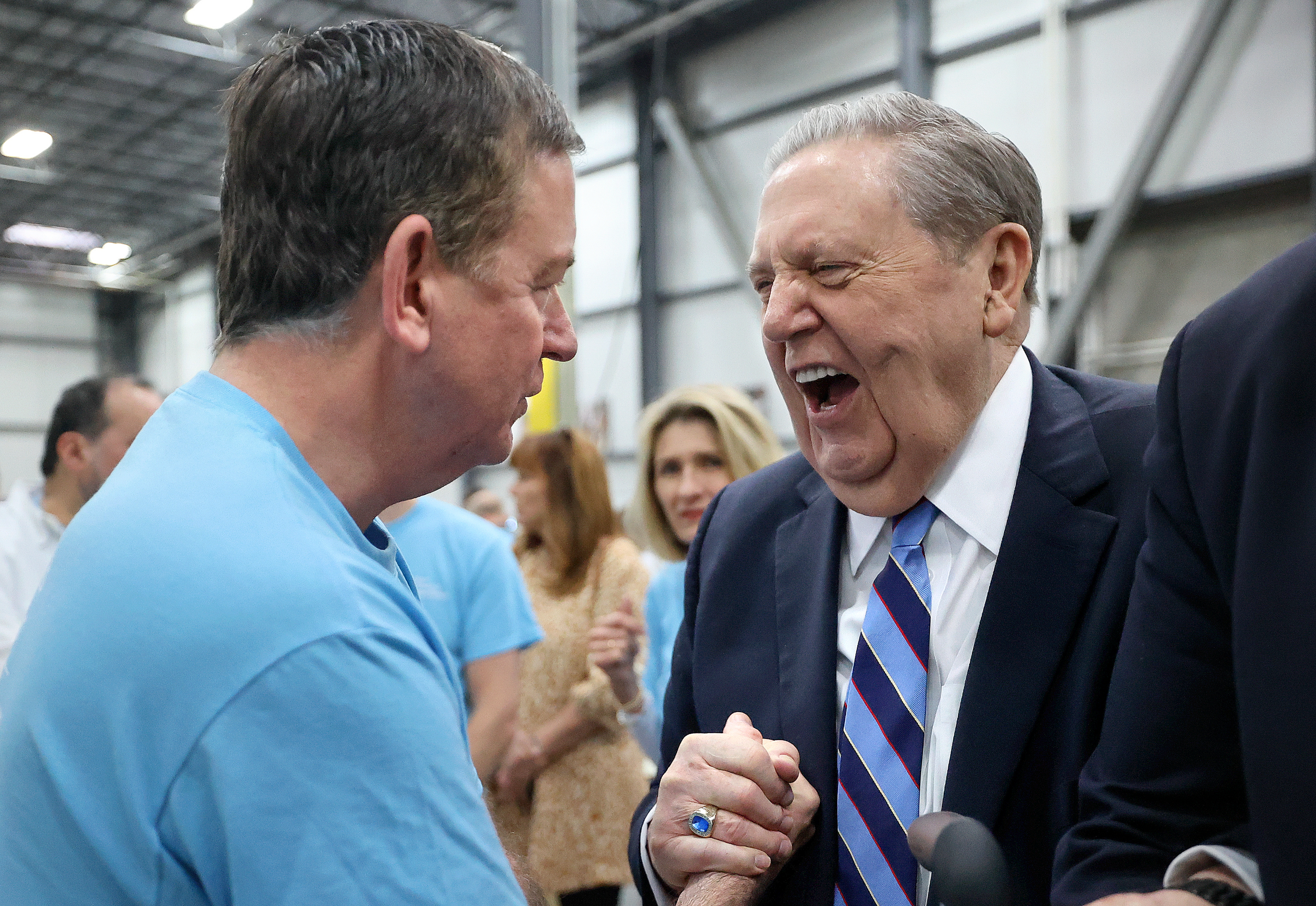 Barron Segar, World Food Program USA president and CEO, shakes hands with President Jeffrey R. Holland, acting president of the Quorum of the Twelve Apostles of The Church of Jesus Christ of Latter-day Saints, during a service day at Bishops’ Central Storehouse in Salt Lake City on Thursday.