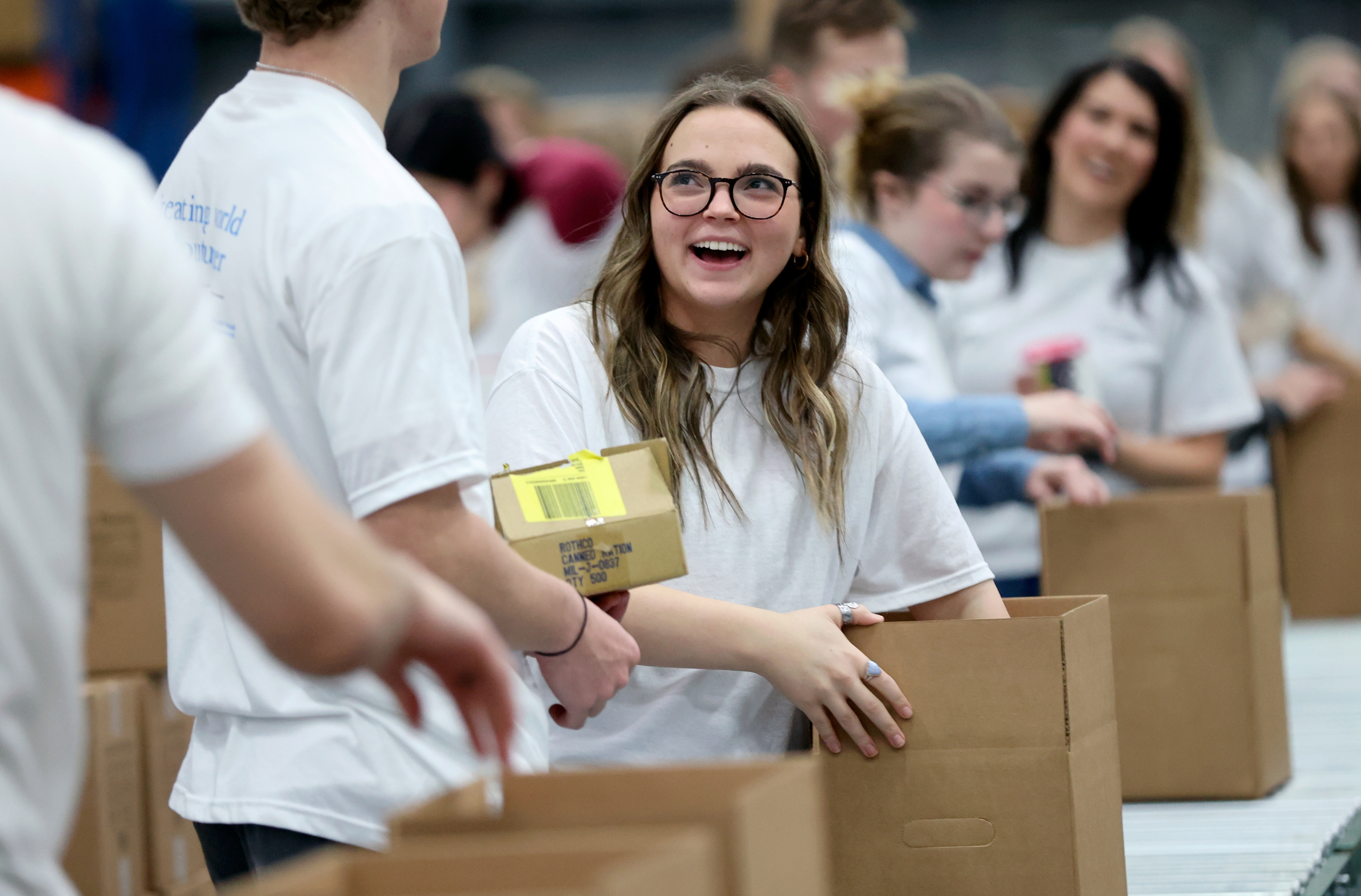 Mary Harden boxes food during a service day, hosted by The Church of Jesus Christ of Latter-day Saints, to commemorate the 10th anniversary of its relationship with the United Nations World Food Programme and World Food Program USA, at Bishops’ Central Storehouse in Salt Lake City on Thursday.