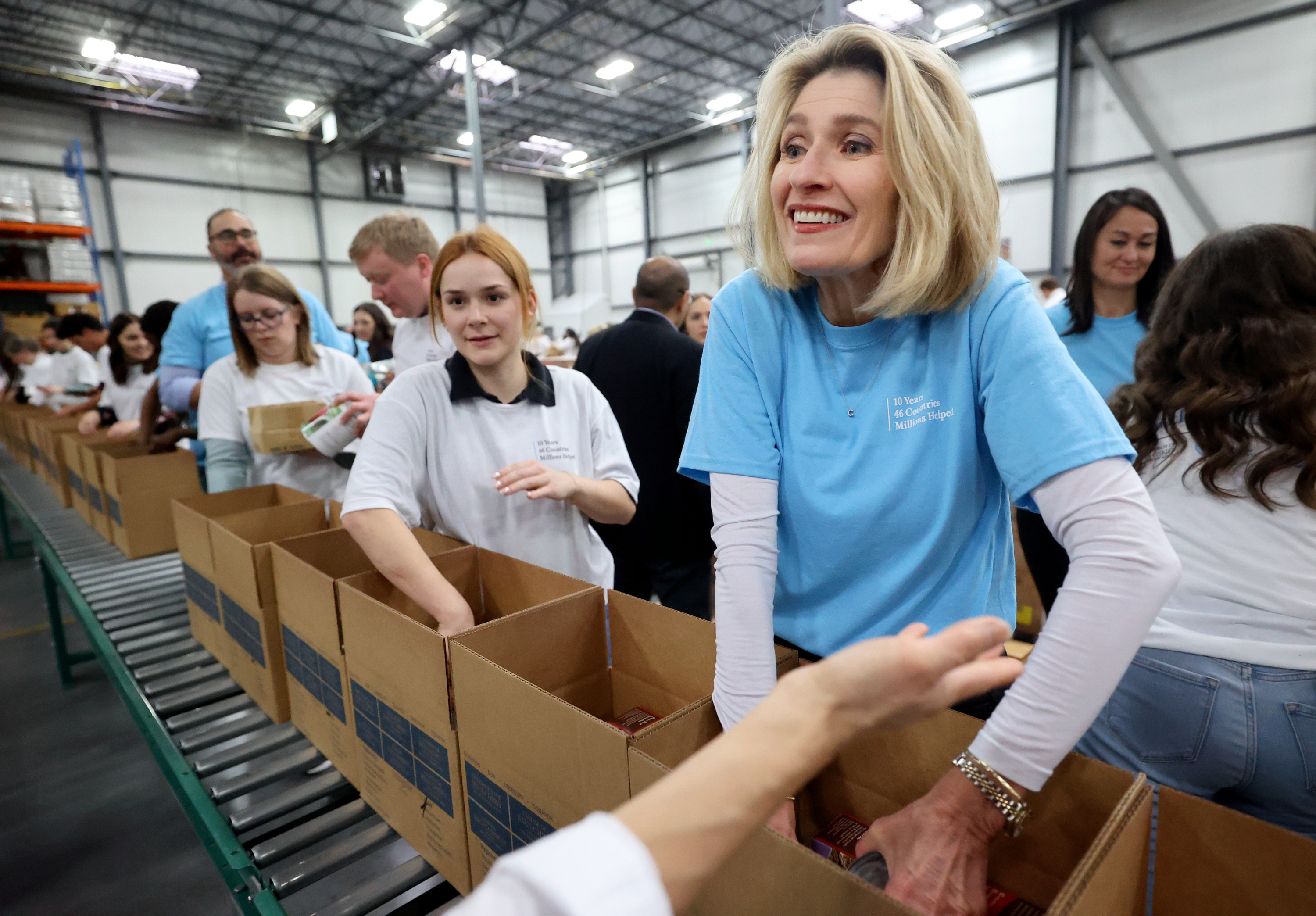 President Camille N. Johnson, Relief Society general president of The Church of Jesus Christ of Latter-day Saints, boxes food during a service day, hosted by the church to commemorate the 10th anniversary of its relationship with the United Nations World Food Programme and World Food Program USA, at Bishops’ Central Storehouse in Salt Lake City on Thursday.