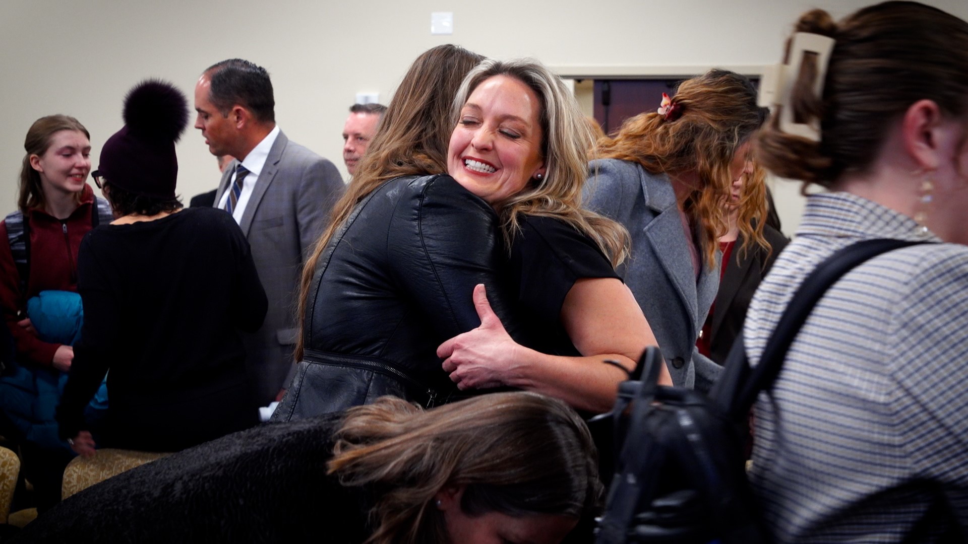 Leah Moses hugs a supporter after a legislative panel advanced a reform bill focused on Utah’s family court system Thursday.