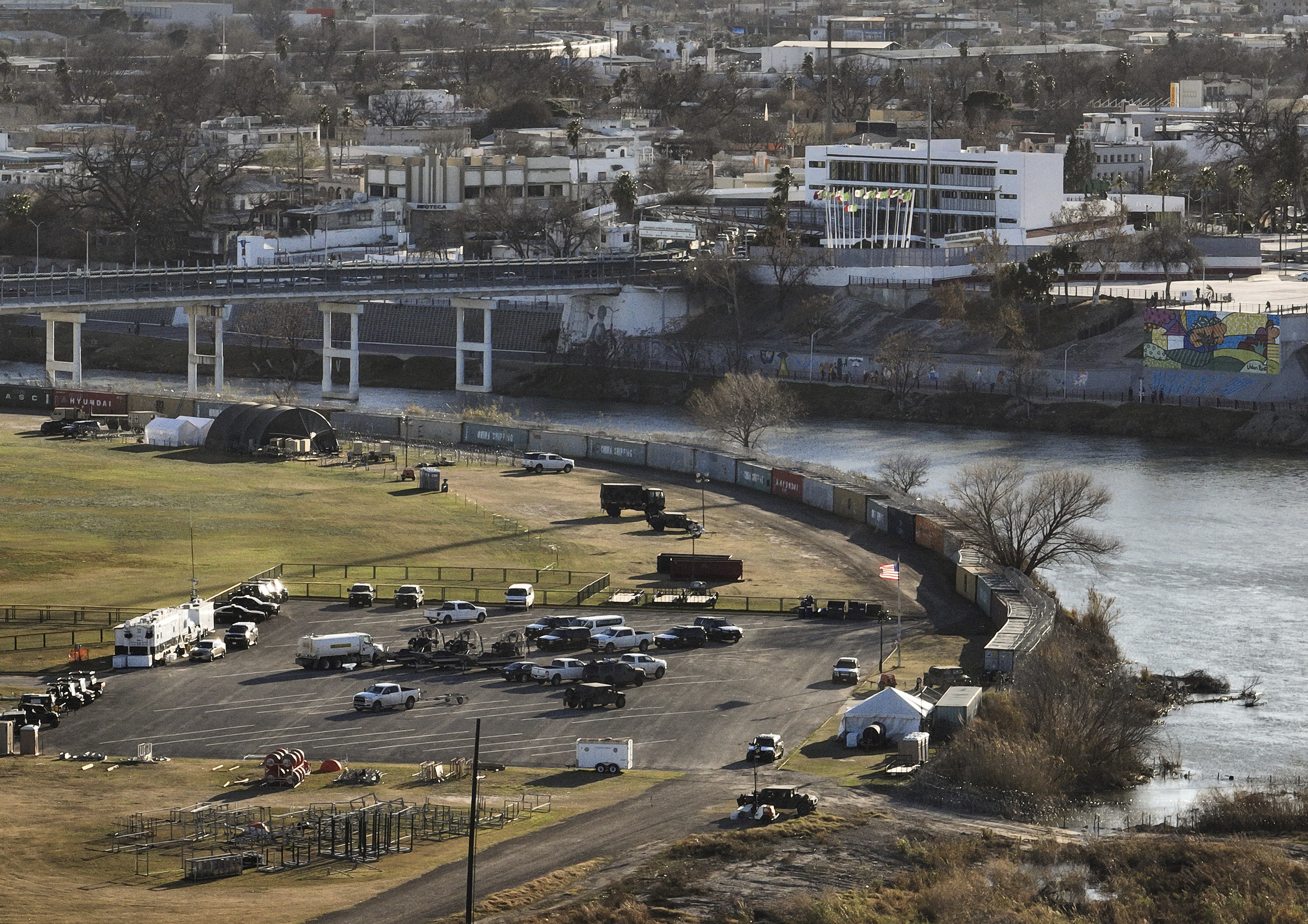Shipping containers and concertina wire line the banks of the Rio Grande, in Shelby Park in Eagle Pass, Texas, across the border from Piedras Negras, Mexico, Sunday, Feb. 4.