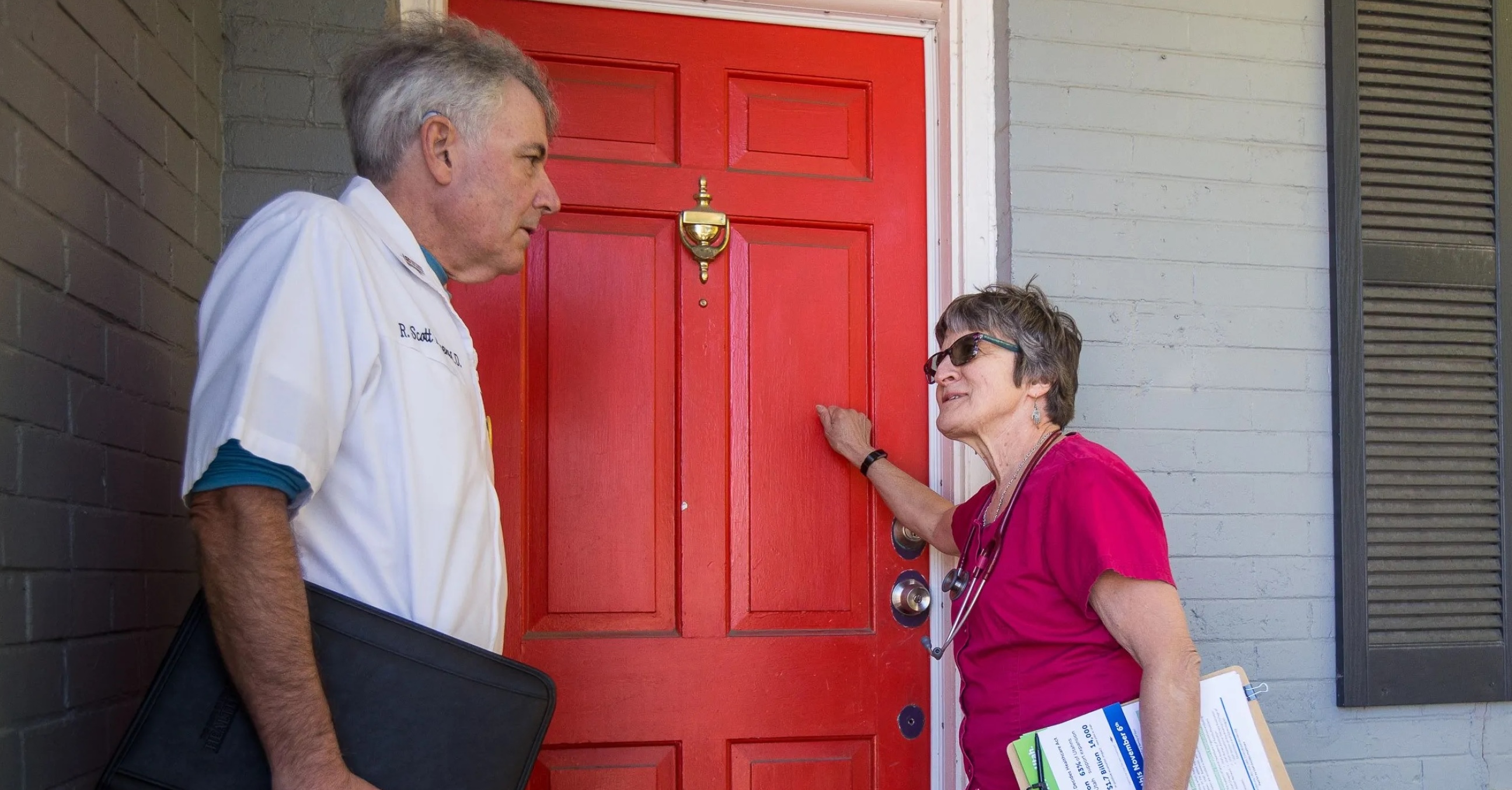 Shirley Belleville and Scott Poppen knock on a door to rally support for a ballot initiative in Salt Lake City on Oct. 13, 2018. 