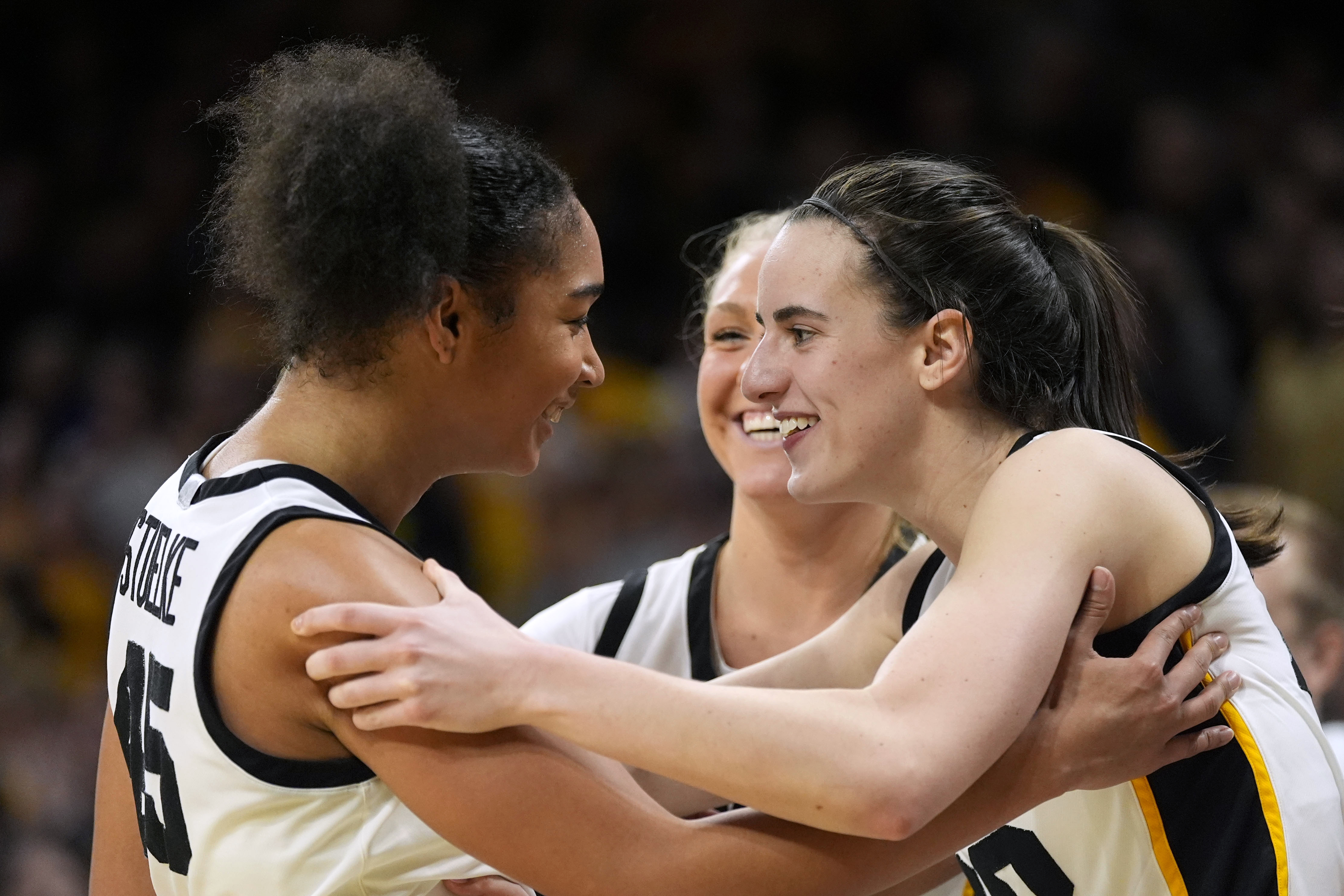 Iowa forward Hannah Stuelke, left, celebrates with teammate guard Caitlin Clark, right, at the end of an NCAA college basketball game against Penn State, Thursday, Feb. 8, 2024, in Iowa City, Iowa. Iowa won 111-93.
