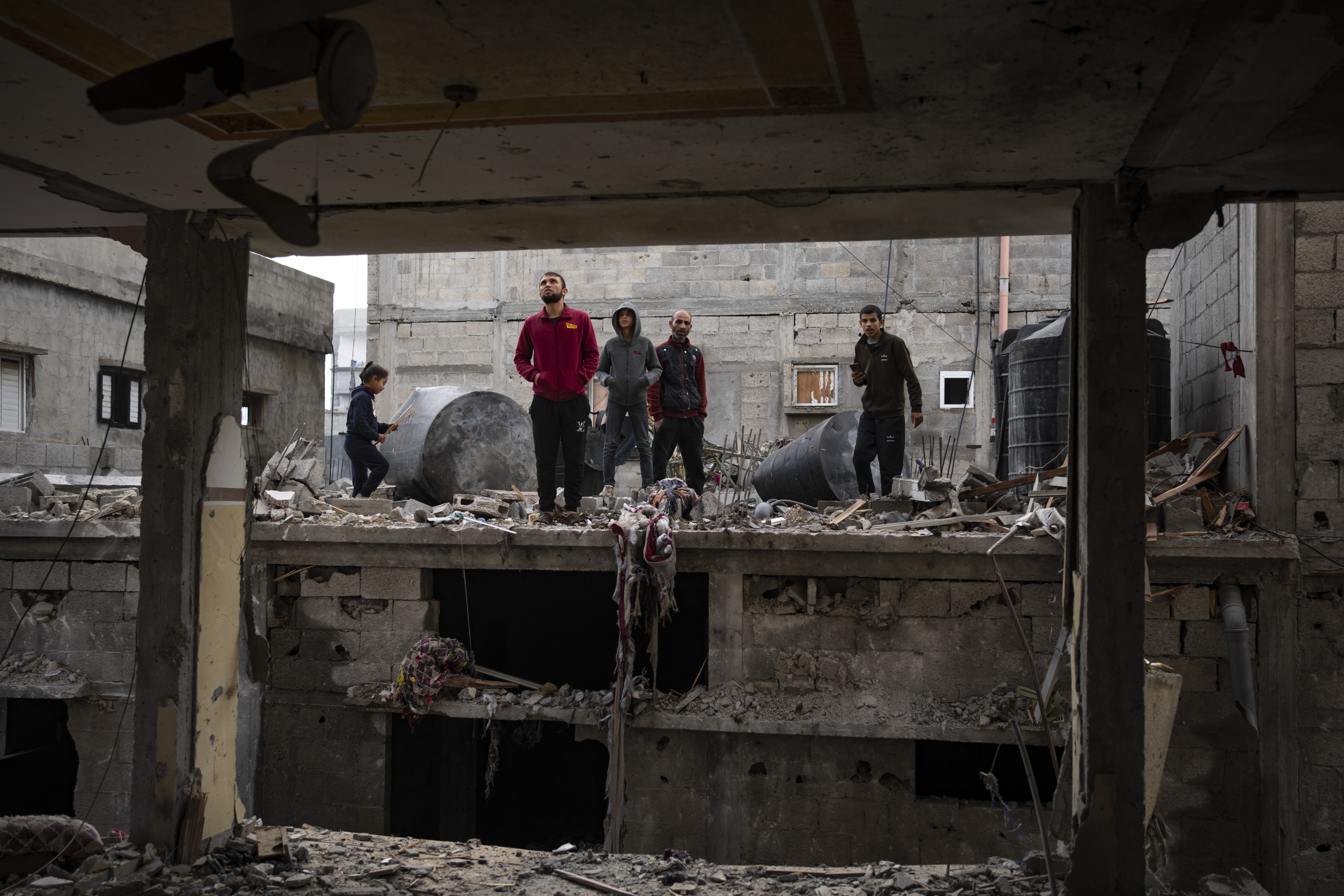 Palestinians look at the destruction after an Israeli airstrike in Rafah, Gaza Strip, Friday. Israeli Prime Minister Benjamin Netanyahu ordered the military to prepare an evacuation plan for the southern Gaza city of Rafah ahead of an expected ground invasion. 