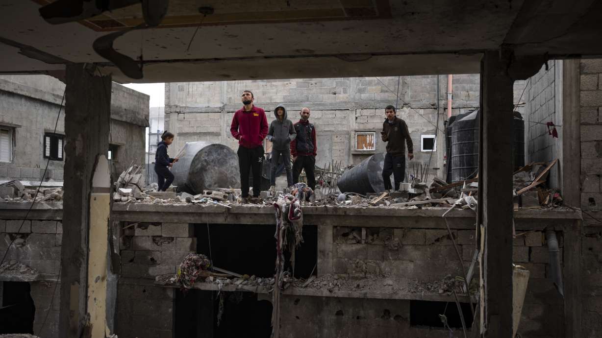 Palestinians look at the destruction after an Israeli airstrike in Rafah, Gaza Strip, Friday. Israeli Prime Minister Benjamin Netanyahu ordered the military to prepare an evacuation plan for the southern Gaza city of Rafah ahead of an expected ground invasion.