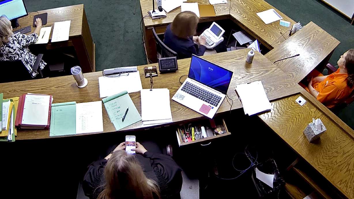 Lincoln County District Judge Traci Soderstrom looks at her cellphone during a murder trial, June 12, 2023, in Chandler, Okla. Soderstrom agreed to resign on Friday.
