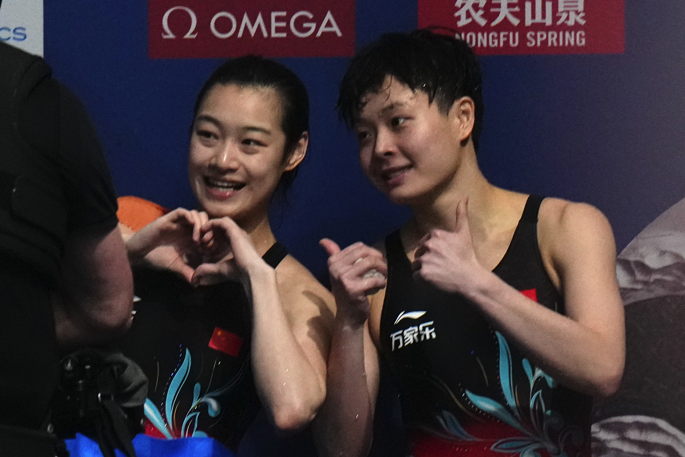 Chang Yani of China, left, and Chen Yiwen of China gesture after winning gold and silver during the women's 3m springboard diving final at the World Aquatics Championships in Doha, Qatar, Friday, Feb. 9, 2024. 