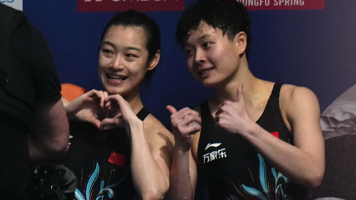 Chang Yani of China, left, and Chen Yiwen of China gesture after winning gold and silver during the women's 3m springboard diving final at the World Aquatics Championships in Doha, Qatar, Friday, Feb. 9, 2024.