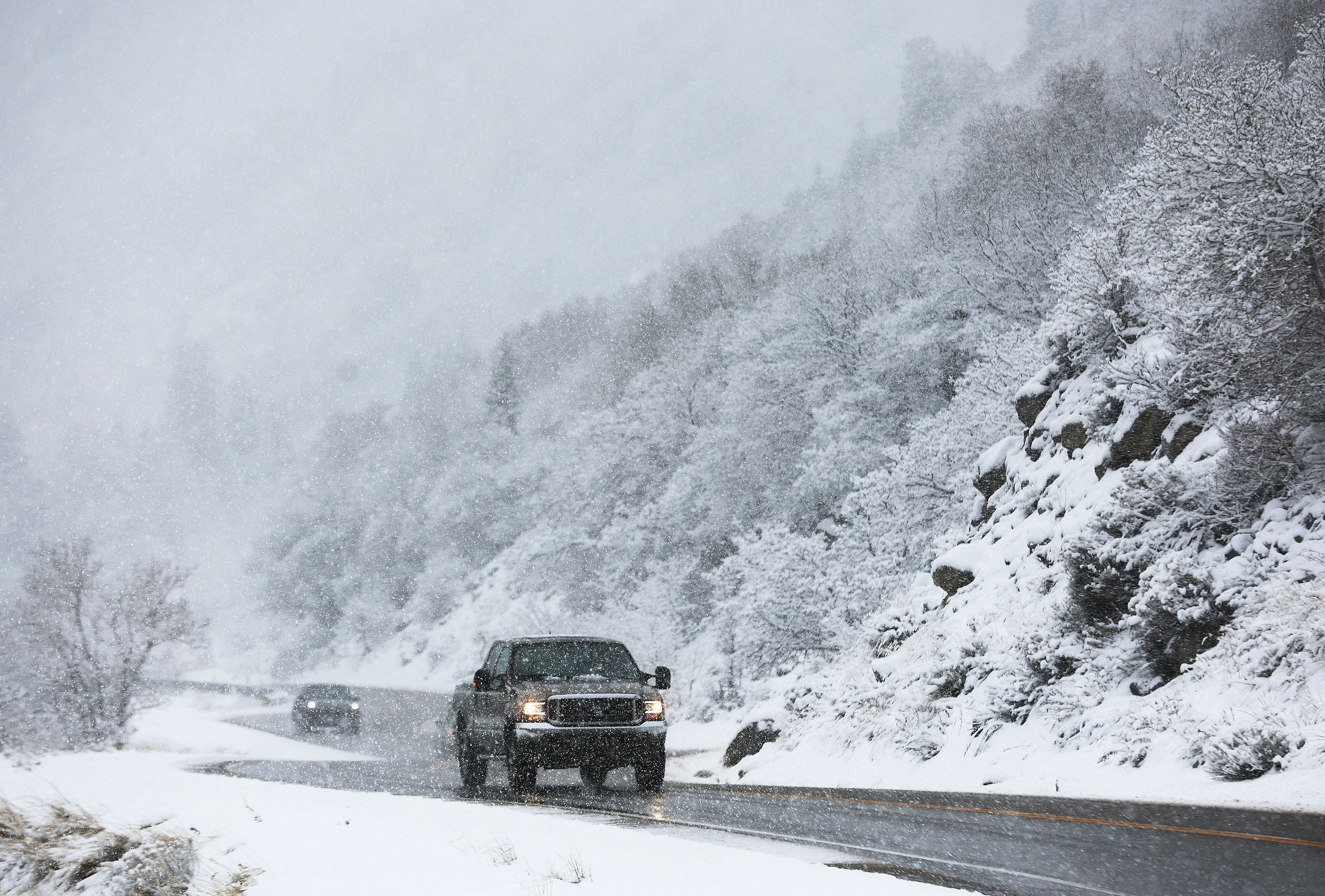 Motorists drive through falling snow in Little Cottonwood Canyon on Wednesday. Every snowpack basin across the state has received a healthy jolt of water in the past week from a pair of atmospheric rivers.