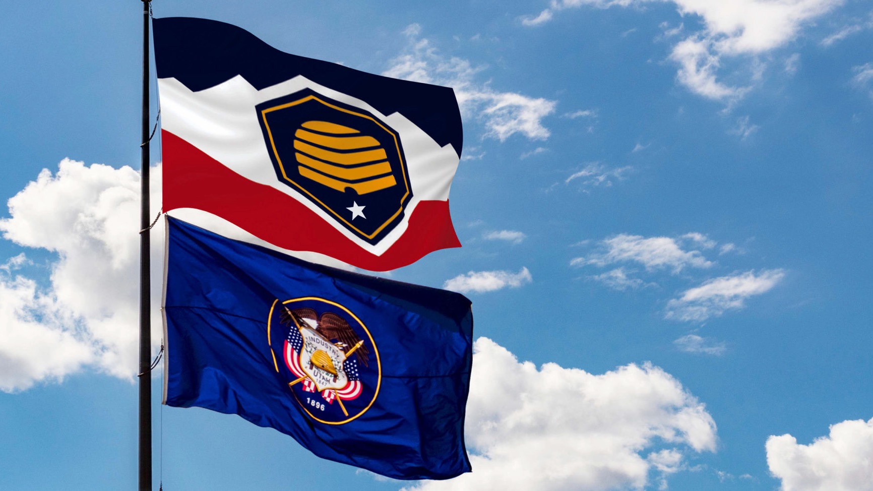 The image shows the flag that's to become Utah's official banner on March 9, on top. The flag on the bottom has been the state flag and would become the "historic state flag."